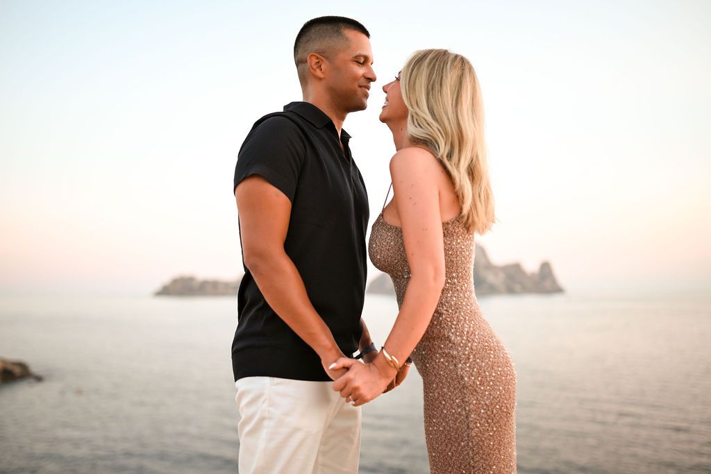 Romantic sunset proposal photo of a couple in Ibiza with sea views.