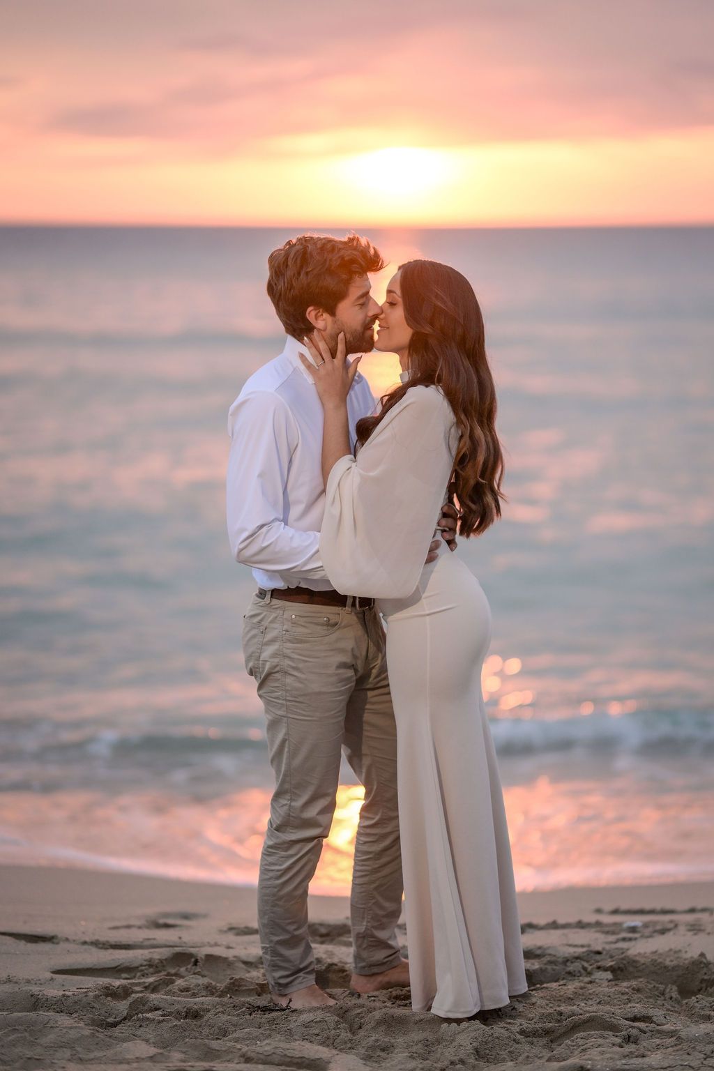 Romantic beach kissing during engagement session in Ibiza