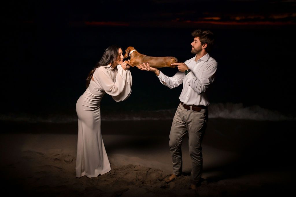 Couple cuddling with their dog during beach photoshoot in Ibiza