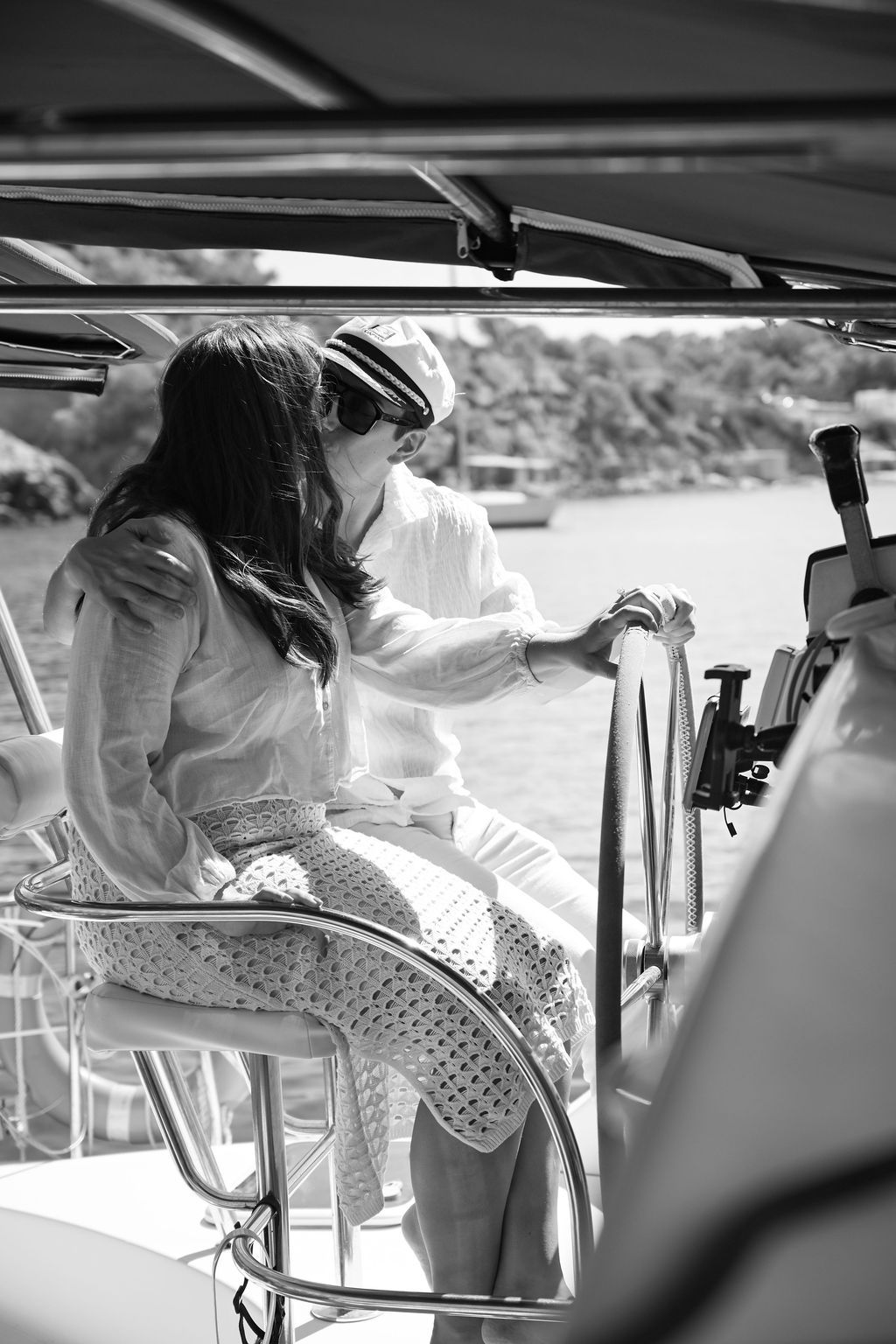 A couple celebrating their engagement during a catamaran proposal in Ibiza.