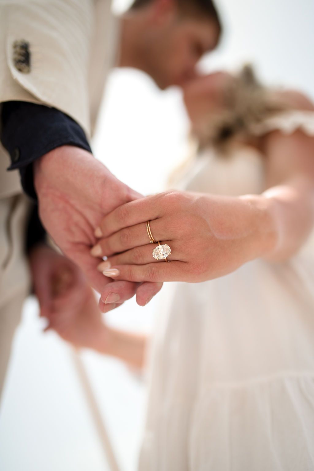 Editorial-style engagement portrait of a couple photographed in Ibiza, ring detail.