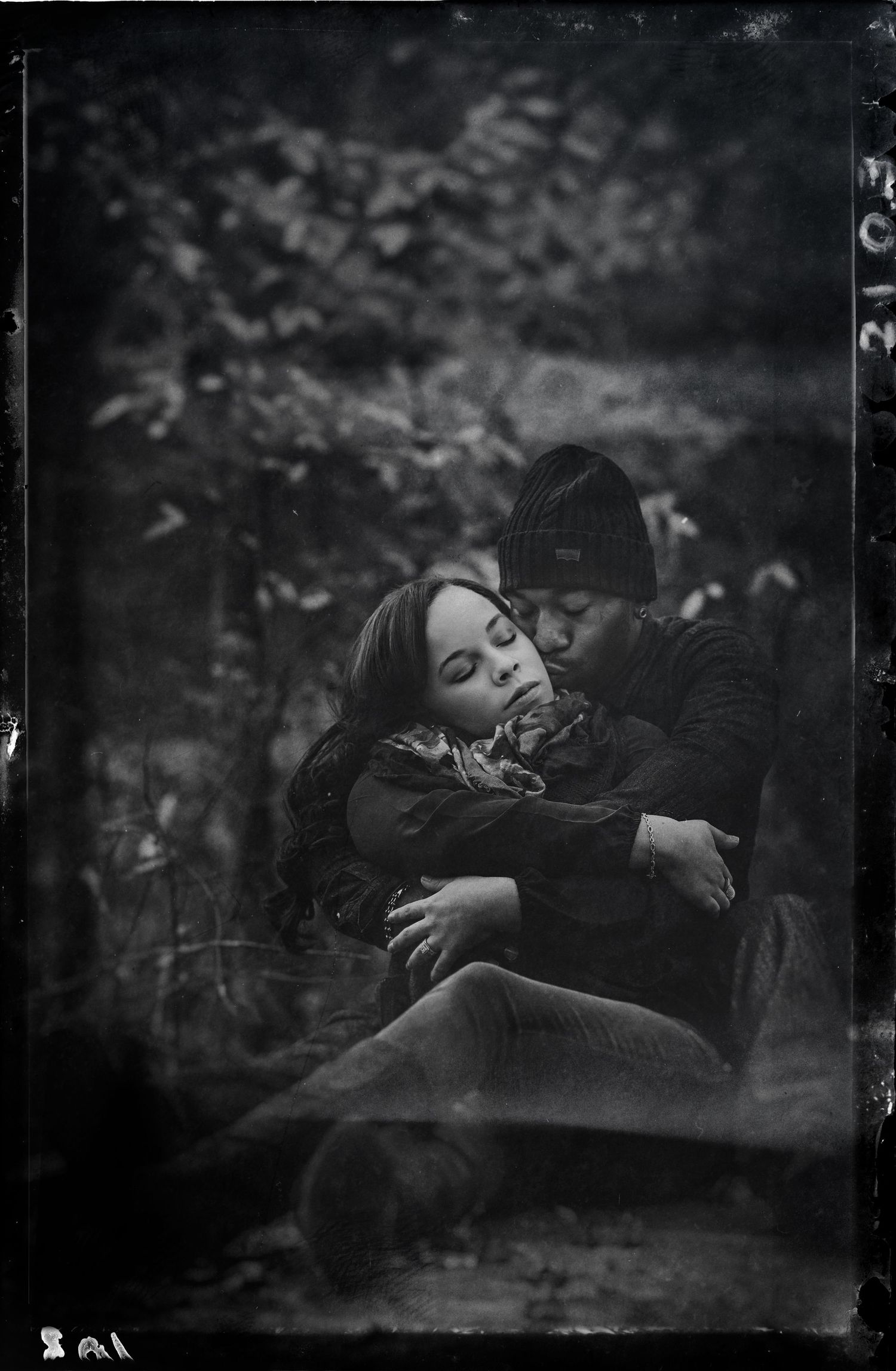 A series of moody black and white photographs showing a person resting in nature with ethereal, dreamlike quality.