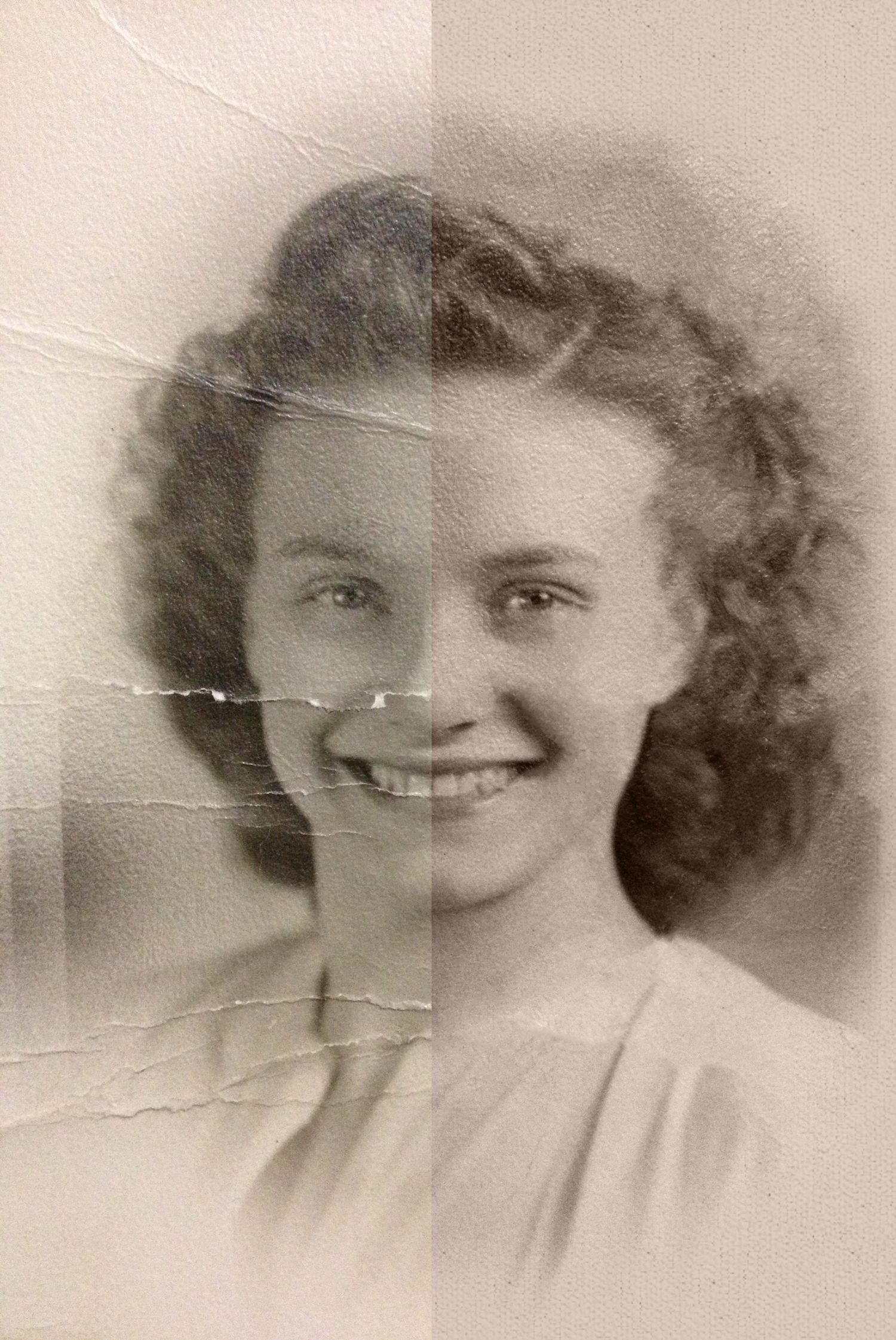 Vintage sepia portrait of a young smiling woman with curly hair, showing age-related cracks and tears on the photograph.