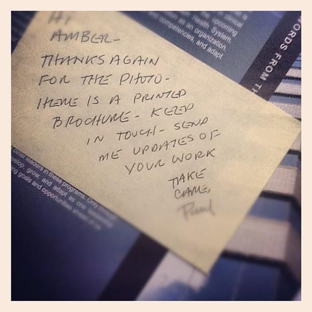 Handwritten note on yellow sticky paper thanking Amber for a photo and including a printed brochure.