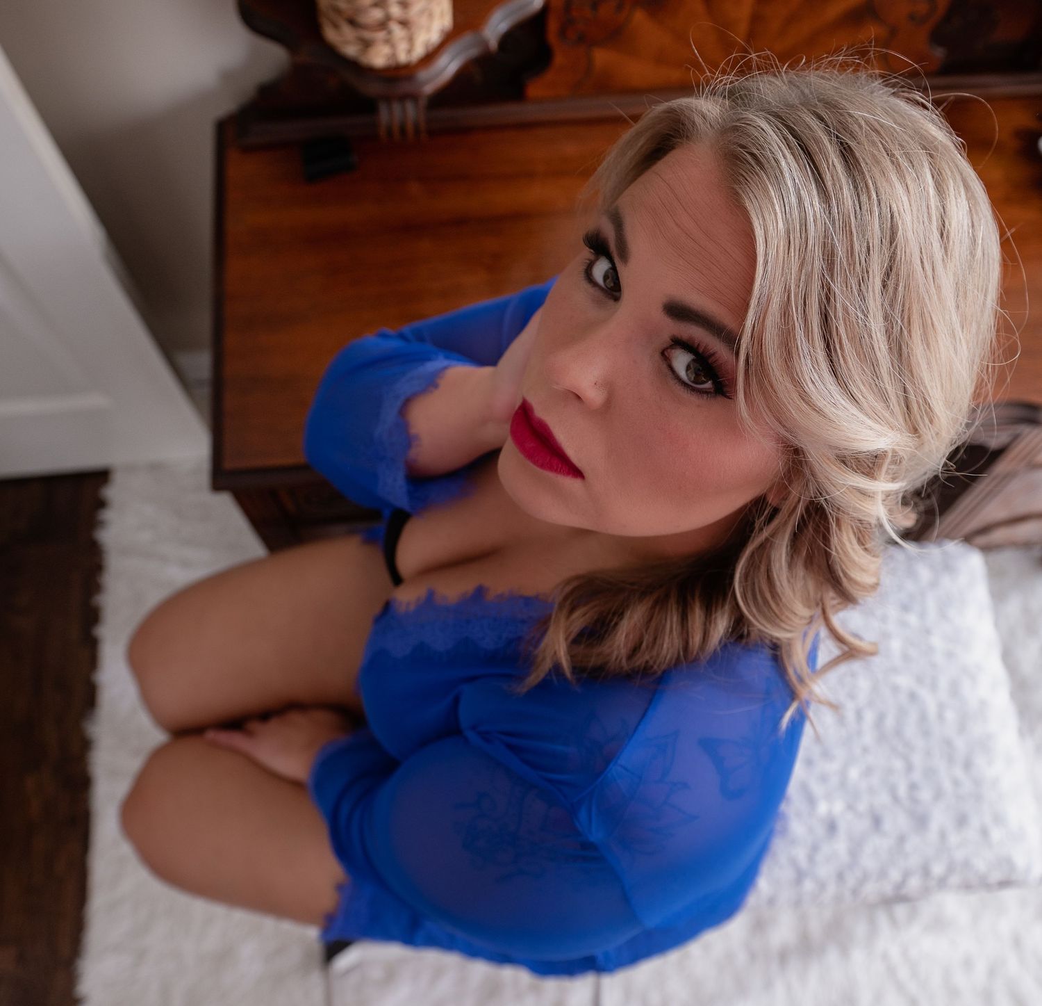 Intimate portrait in vibrant blue lingerie against white backdrop.