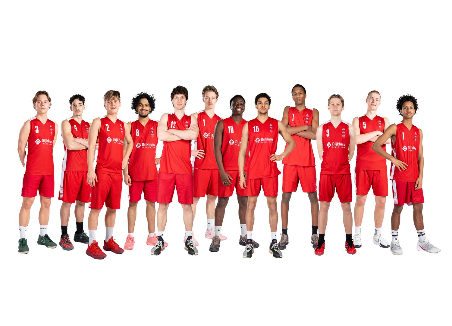 Youth basketball team in red uniforms posing together for a team photo against a white background.