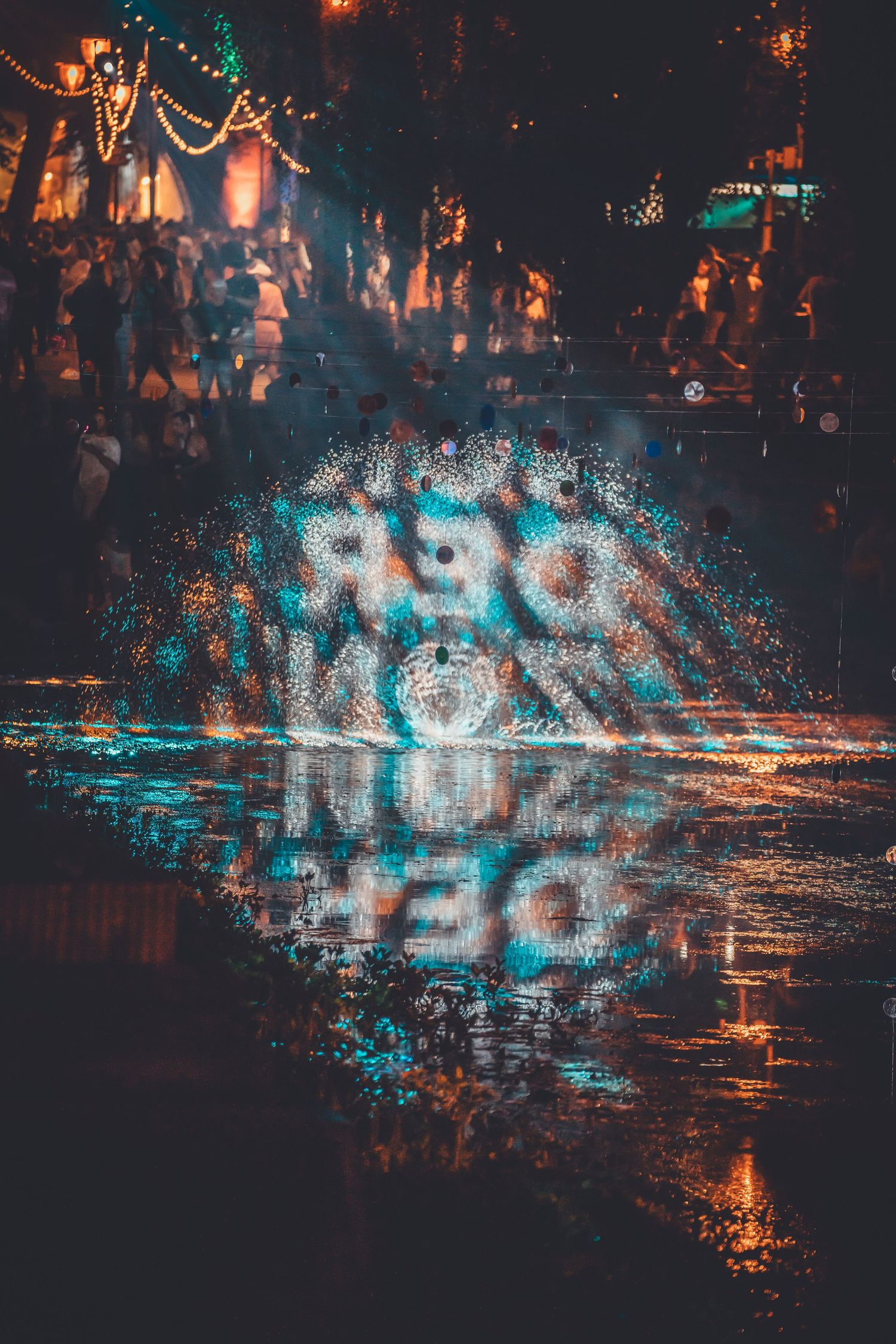 Reflective blue lights and text create a moody nighttime atmosphere with bokeh effects in an urban setting.