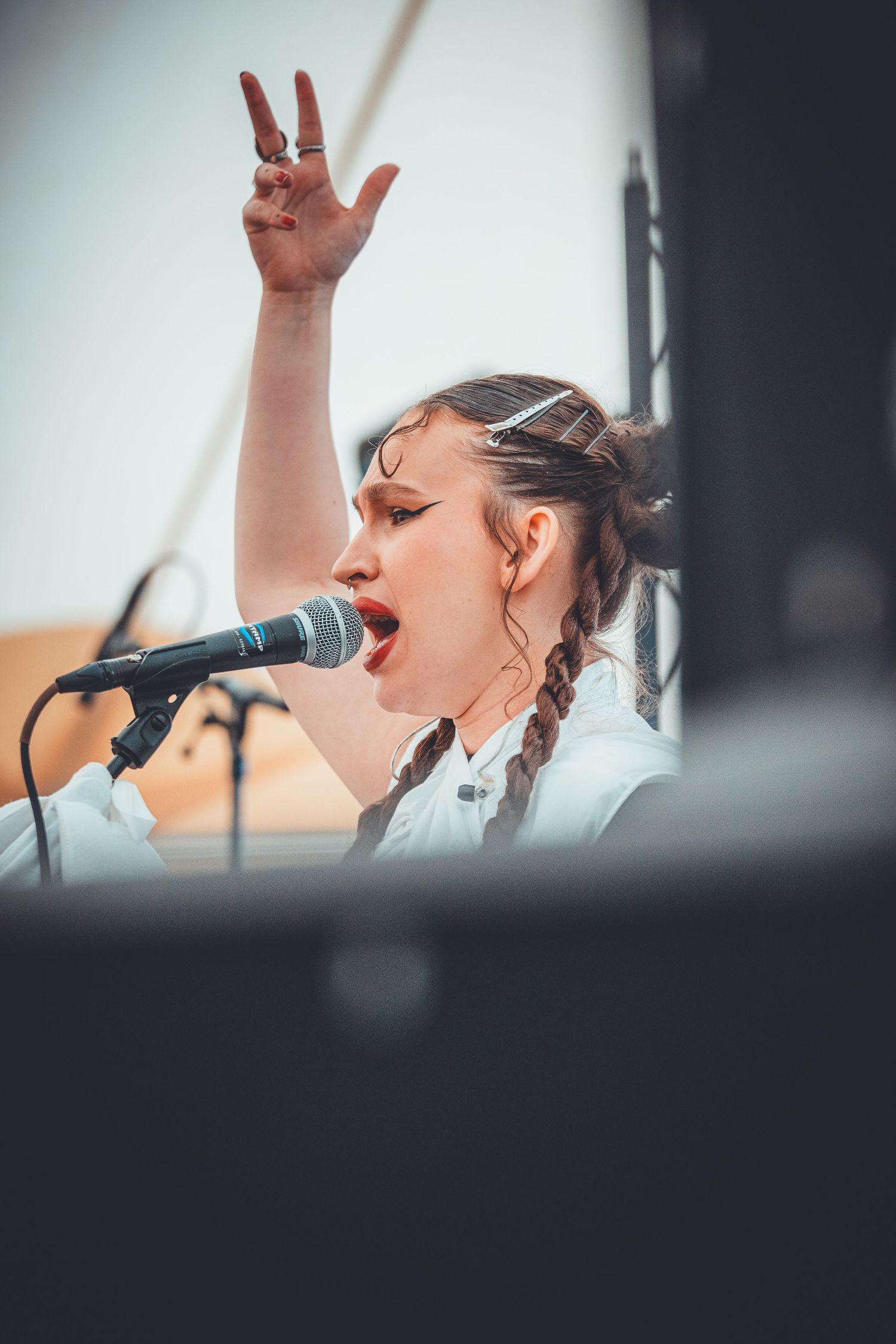 A singer performs passionately on stage holding a microphone in a series of sequential shots.