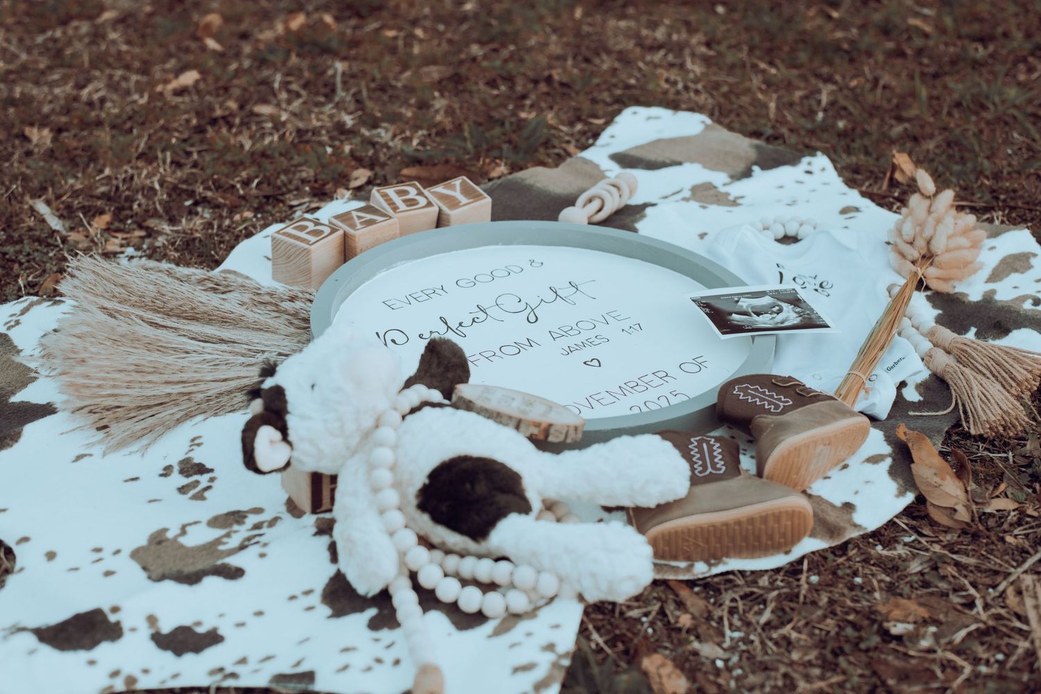 Broken pieces of white ceramic or plaster scattered on dark soil.
