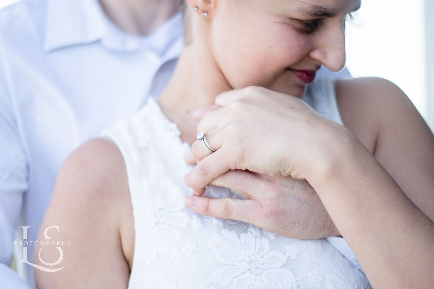 Intimate close-up portrait showing tender embrace in soft lighting.