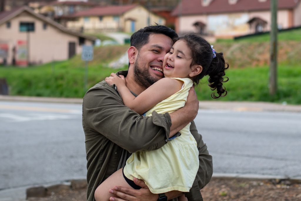 A sweet embrace shared between two people on a residential street.
