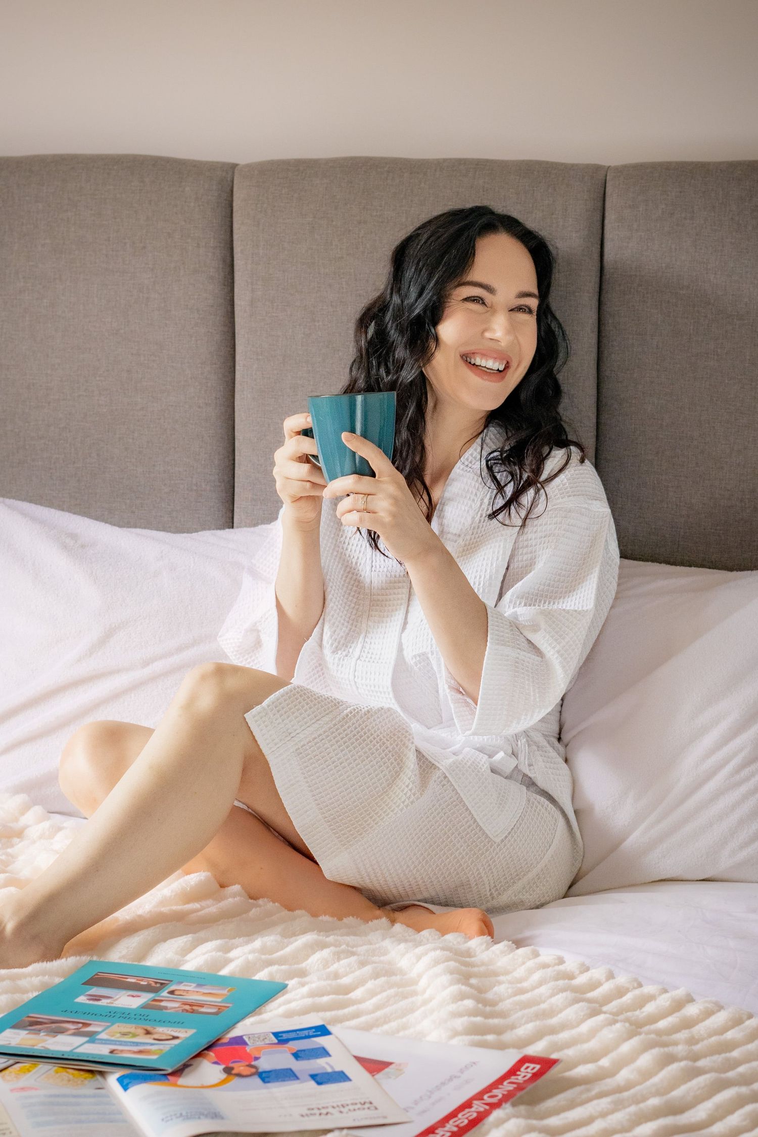 woman on bed with mug
