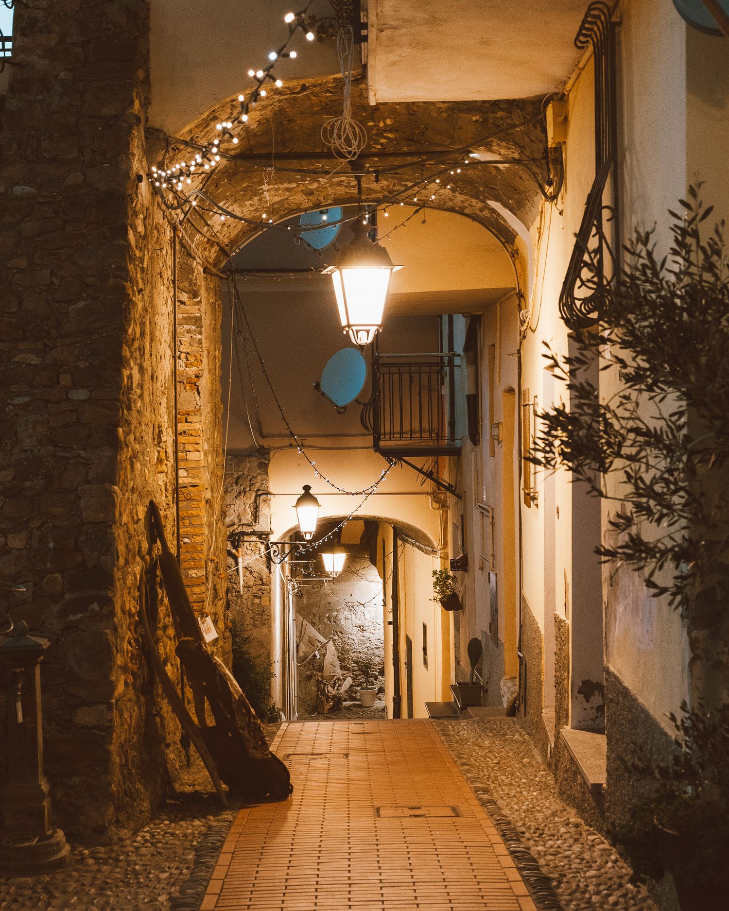 Charming cobblestone street in an Italian village, with rustic buildings and colorful shutters creating a cozy atmosphere