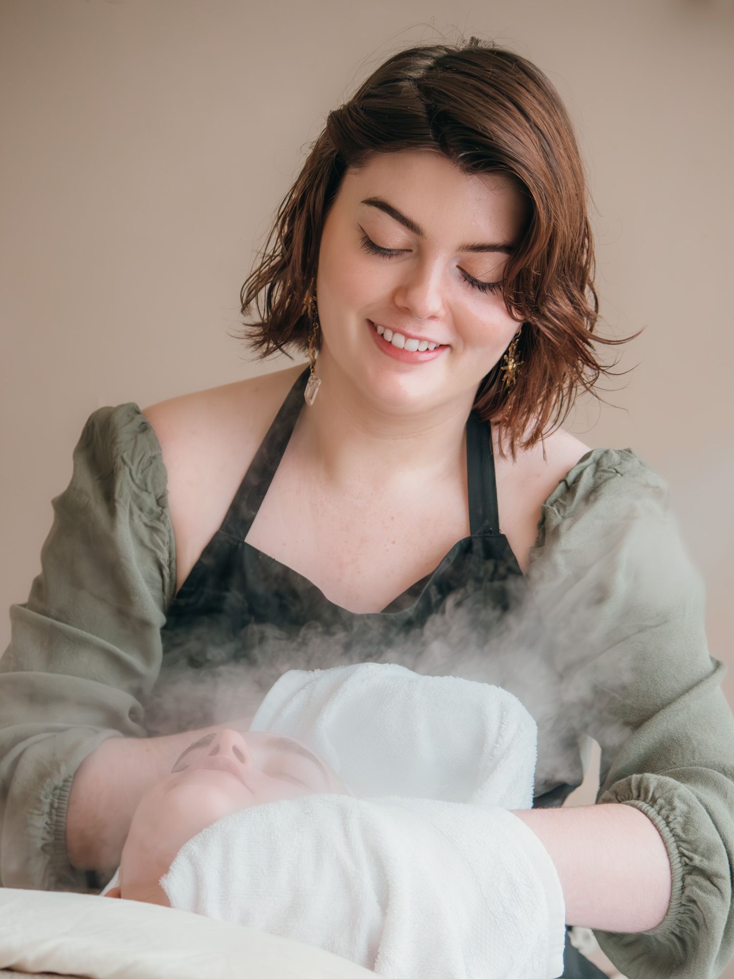 Commercial photography of an Esthetician doing a facial service on a client.