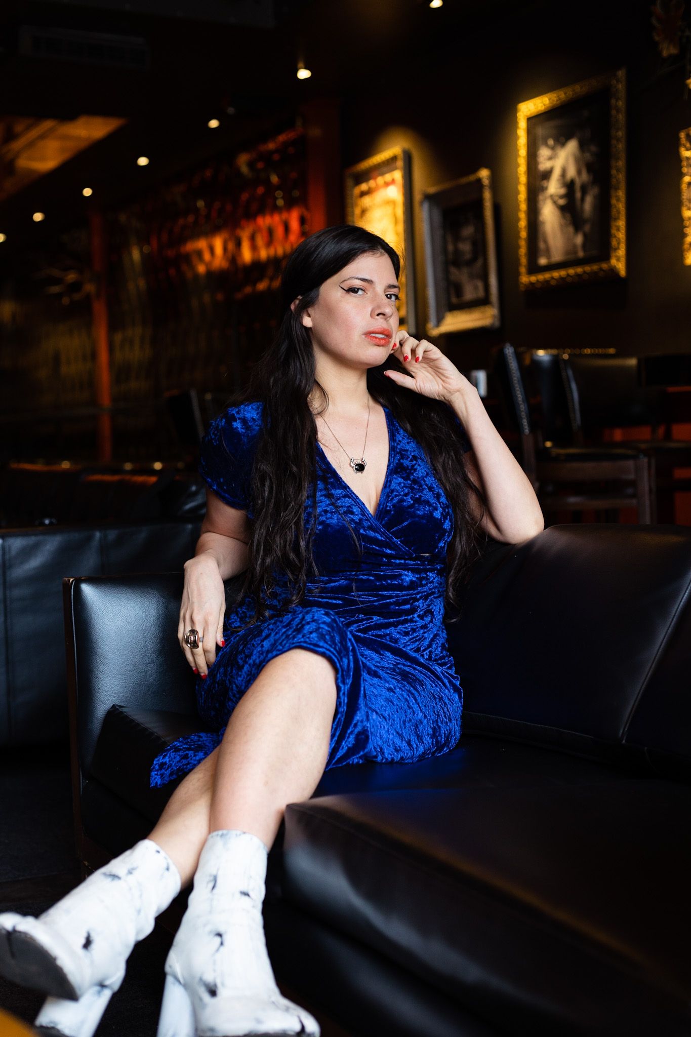 Indoor model strikes a pose in a jazz bar.