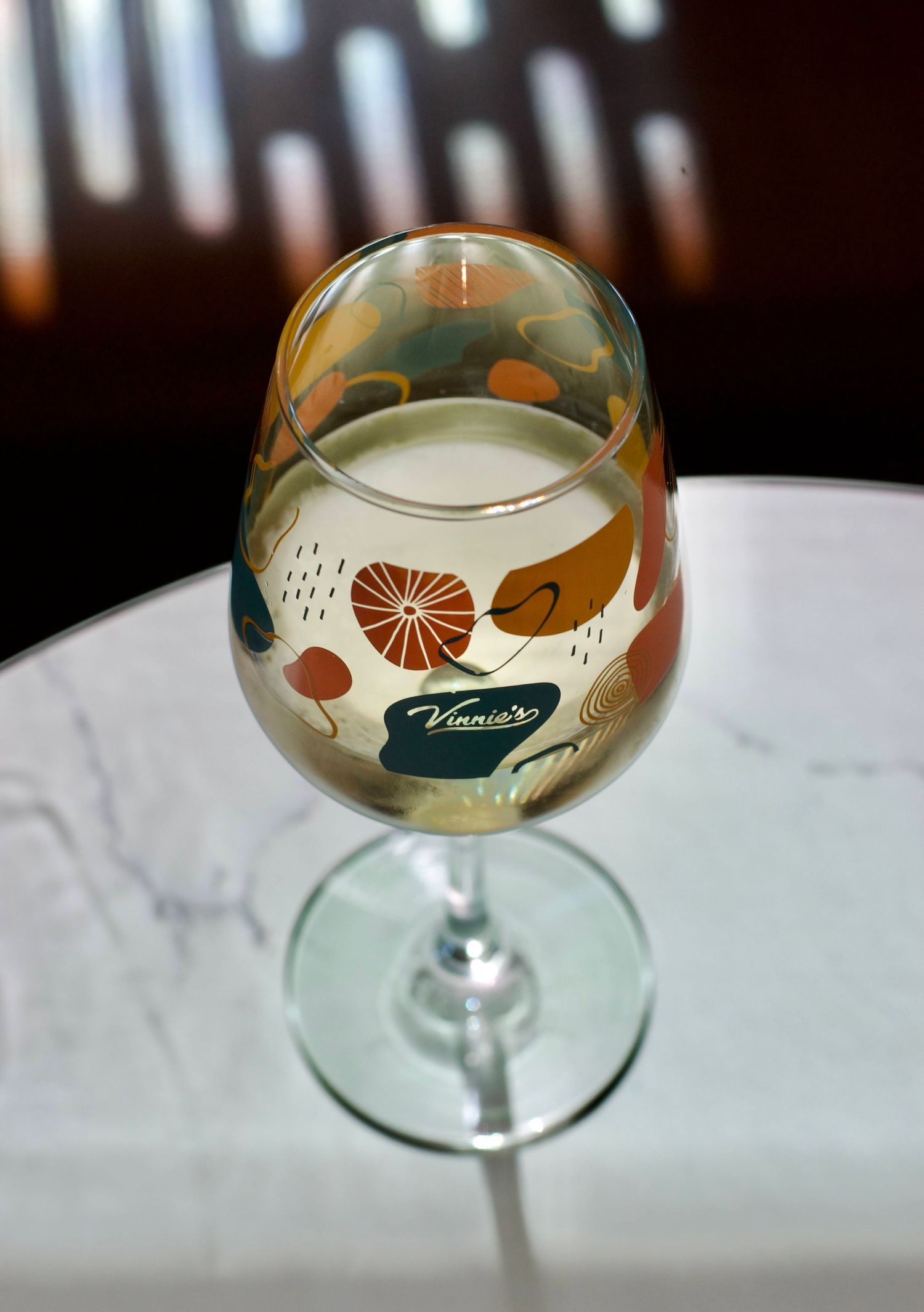 A glass of white wine in soft lighting for a commercial photoshoot.