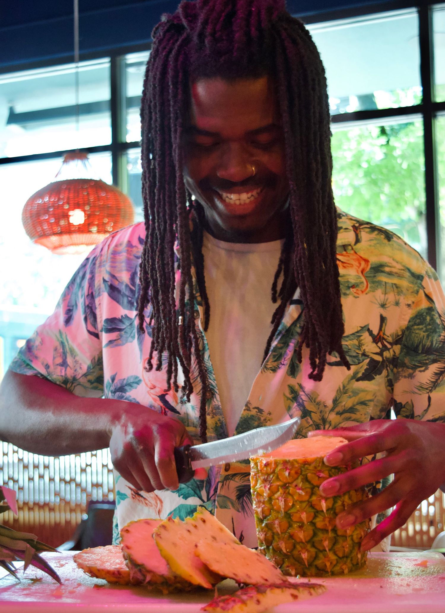 Bartender skillfully shaking a cocktail in a sleek bar, with soft lighting and glassware creating an inviting atmosphere.