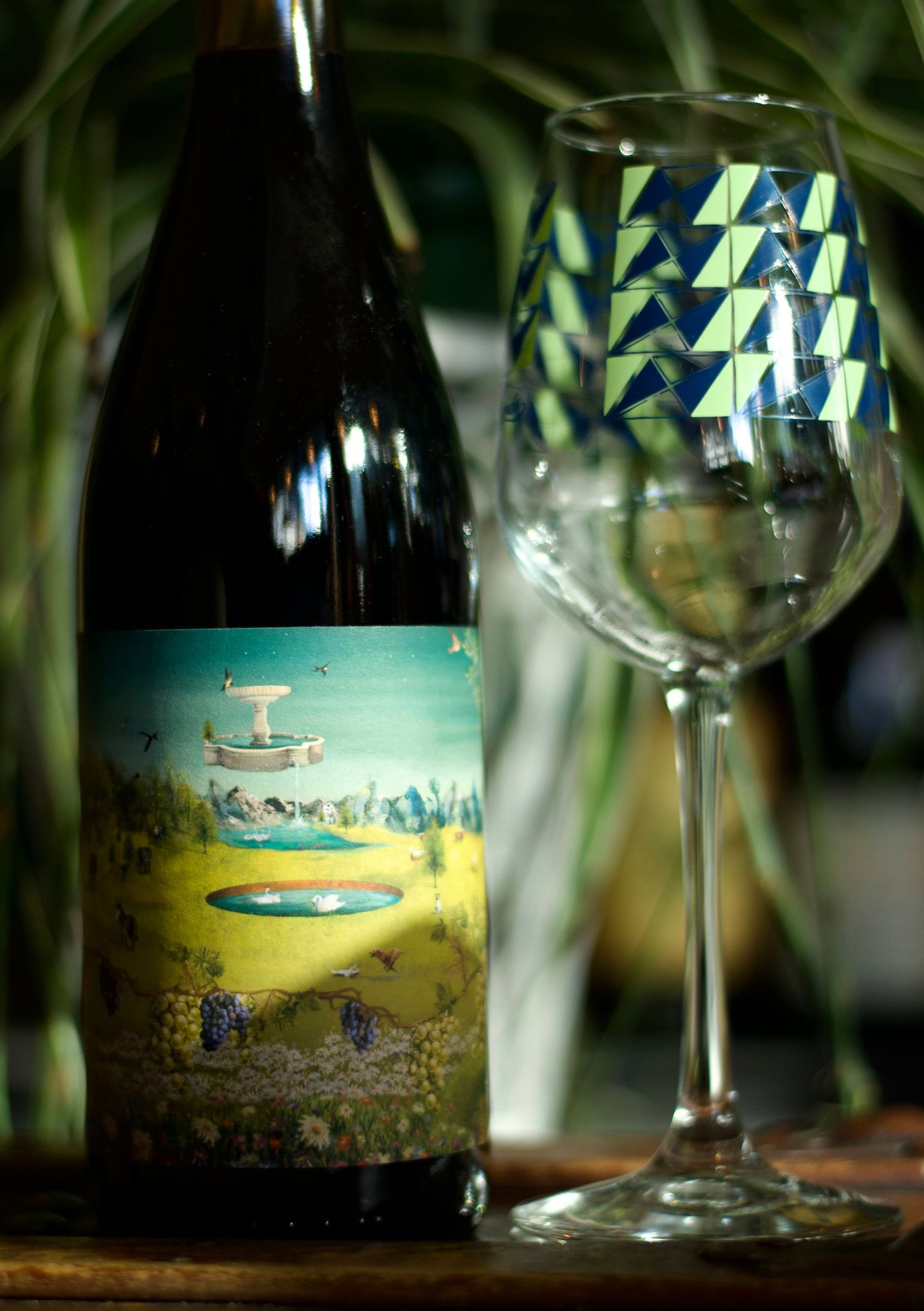 Commercial photography for a local wine bar. A wine glass and bottle surrounded by soft lighting.