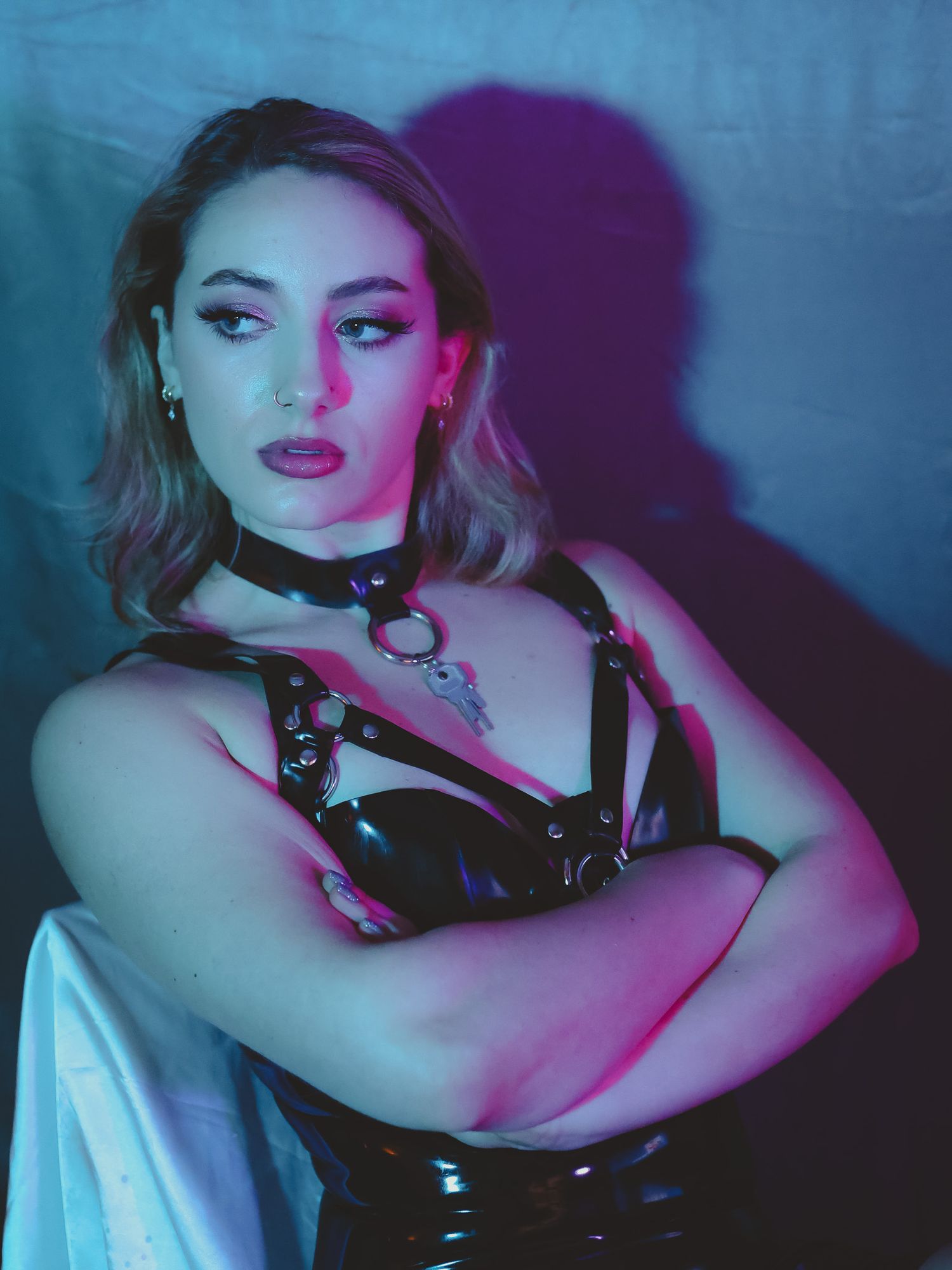 Model posing in a dramatic high fashion outfit, with bold makeup and soft lighting highlighting the look