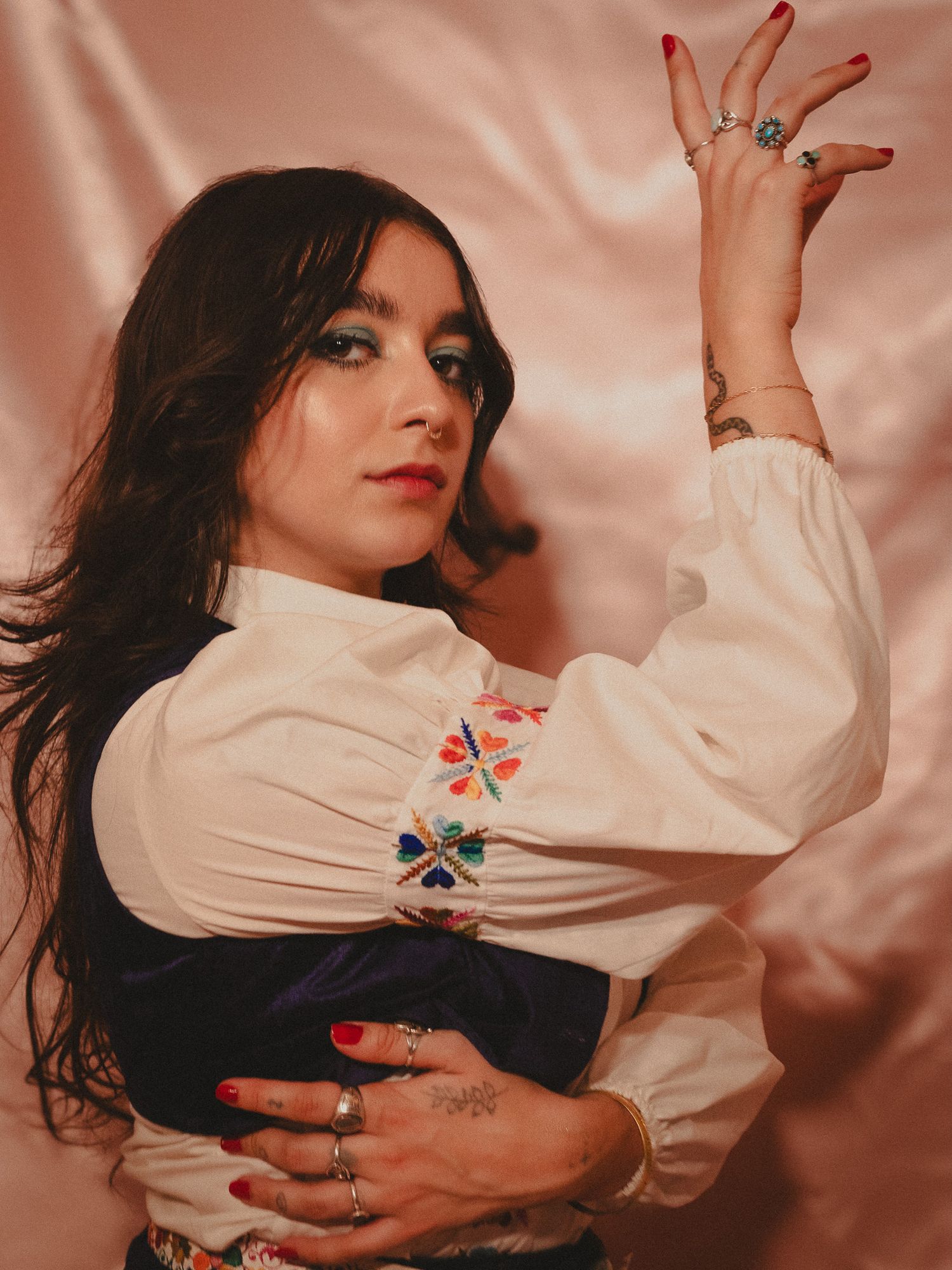 A model posing in a fashion-forward outfit, highlighting their confident expression and unique style.