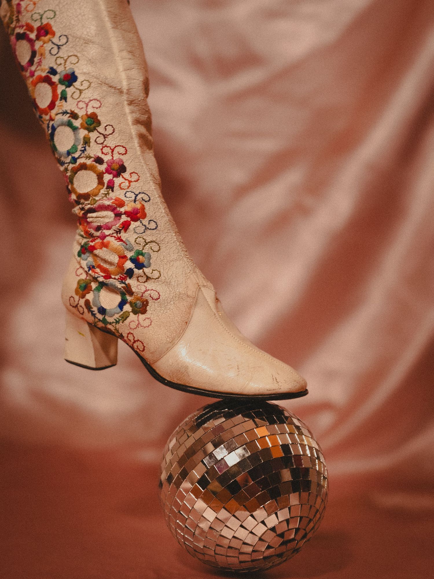 High fashion photoshoot with vintage boot and disco ball.