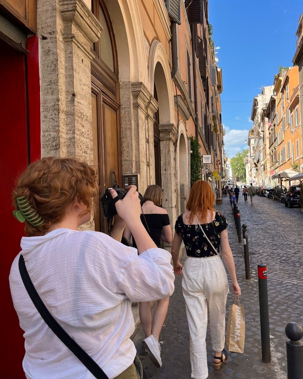 Photographer poses with her camera during her travels.