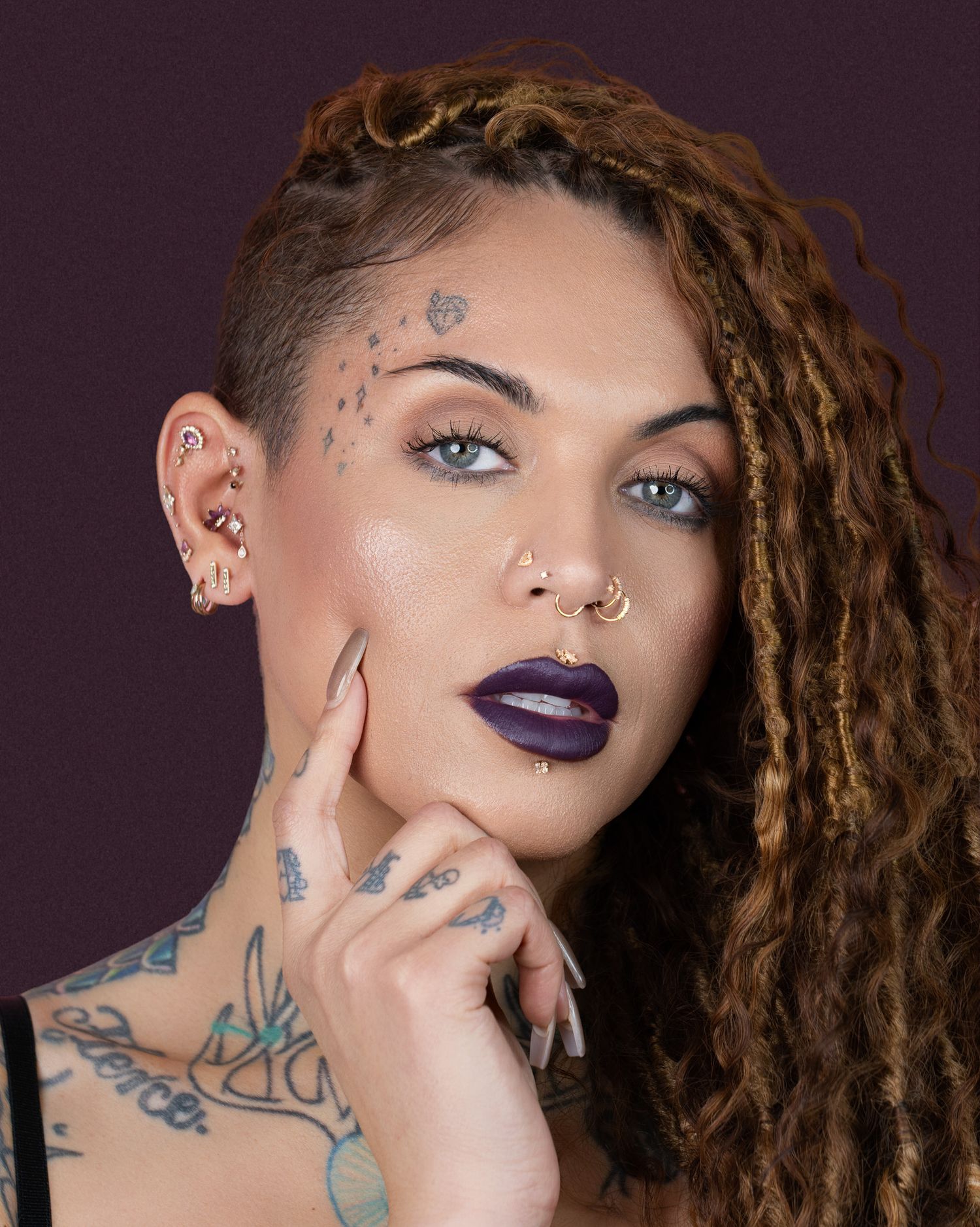 Close-up of a model showcasing avant-garde fashion, with a carefully styled outfit and strong, confident expression, set against a minimalis