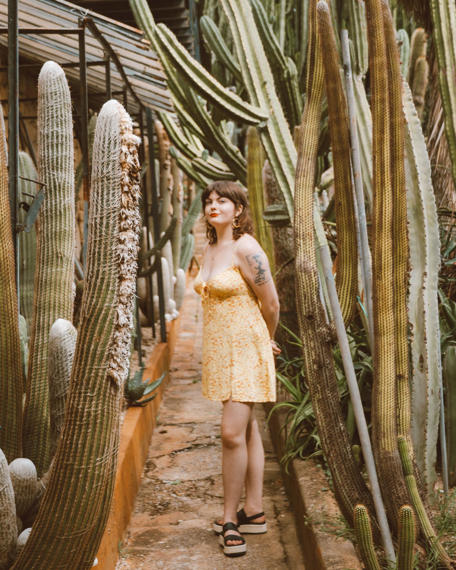 Outdoor portrait of a model, with soft natural light creating a relaxed, earthy vibe in the background