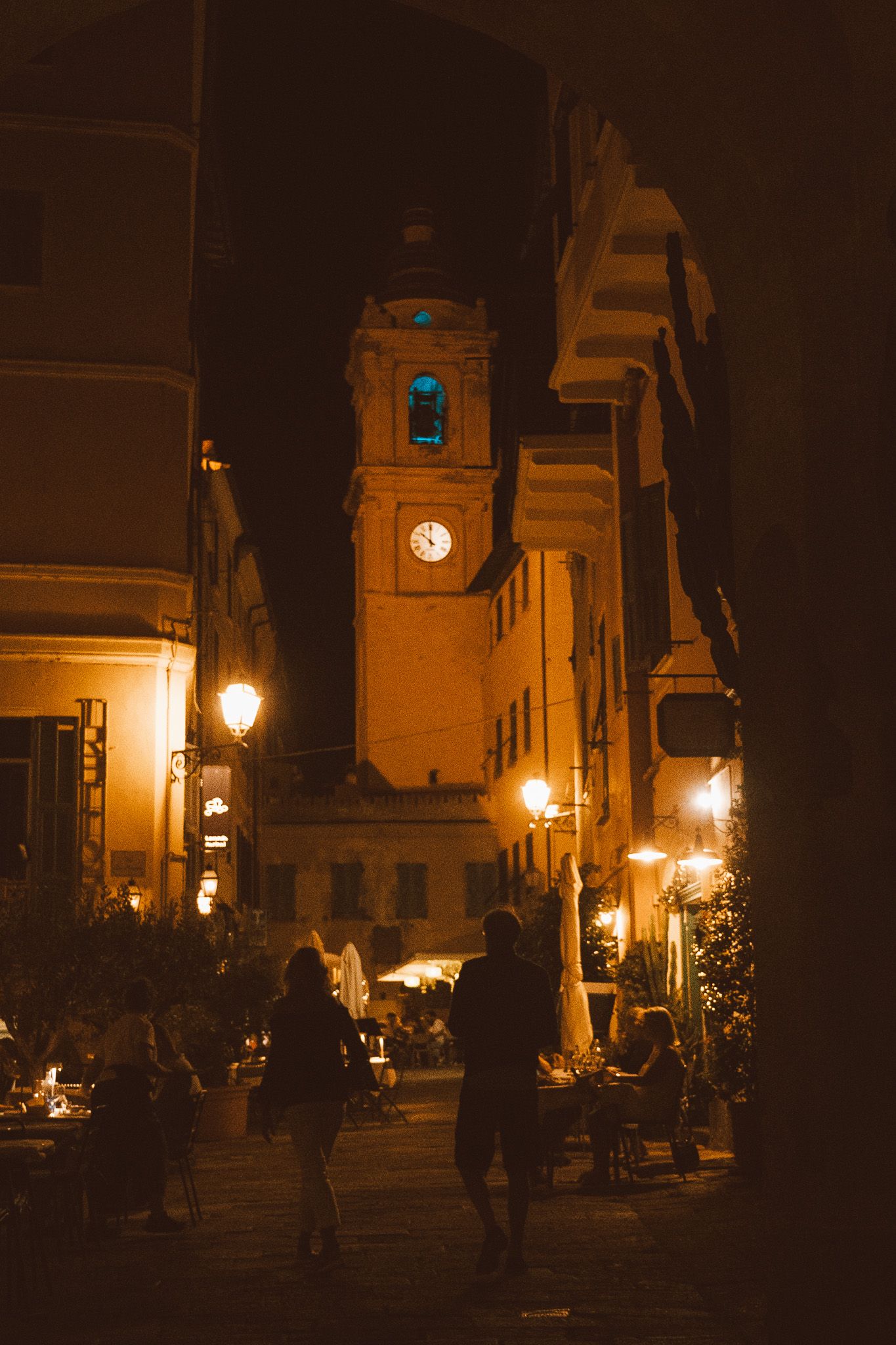 A quiet corner of an Italian village, with ivy-covered buildings and a charming, timeless atmosphere.
