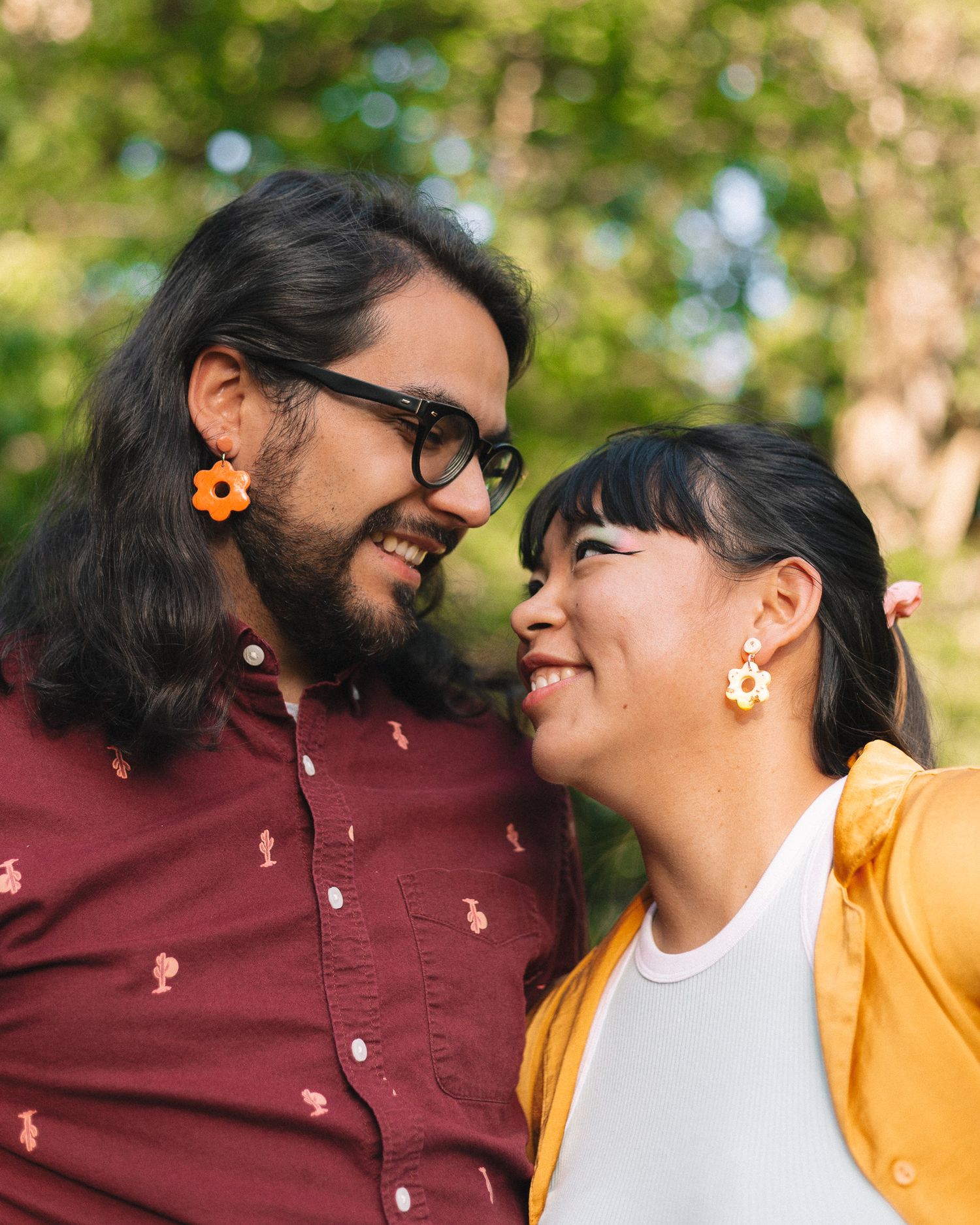 A couple staring lovingly at each other outdoors during a jewelry photoshoot.
