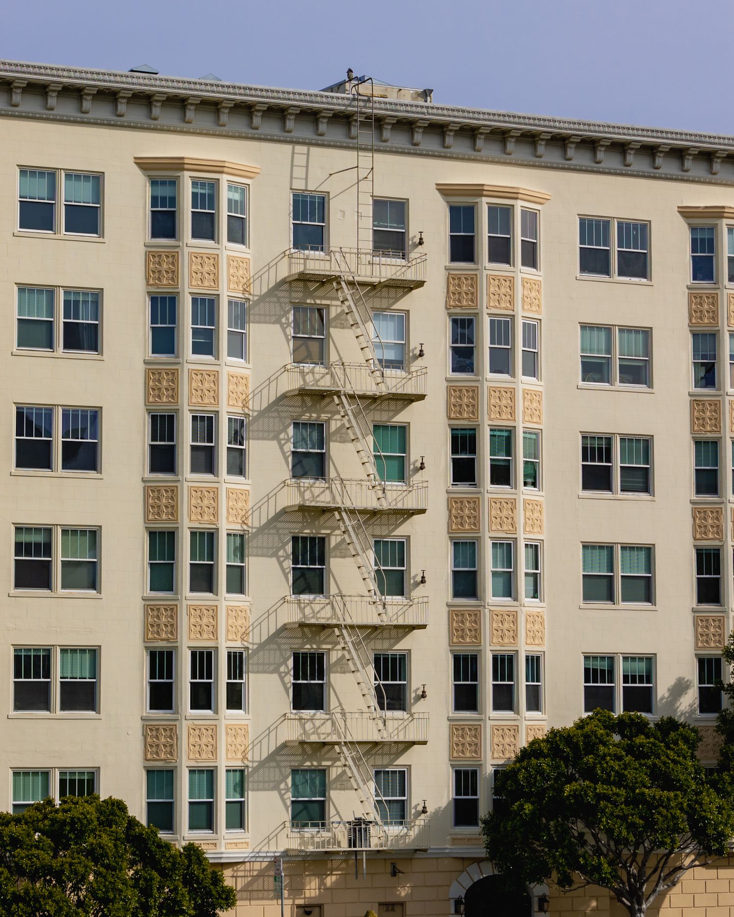 Close-up of an elegant building façade, showcasing intricate details and the contrast of shadows and light.