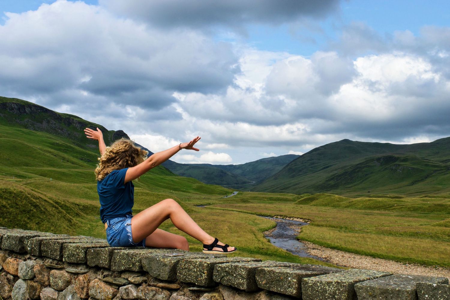 A model posing whimsically outside in the Scottish highlands.
