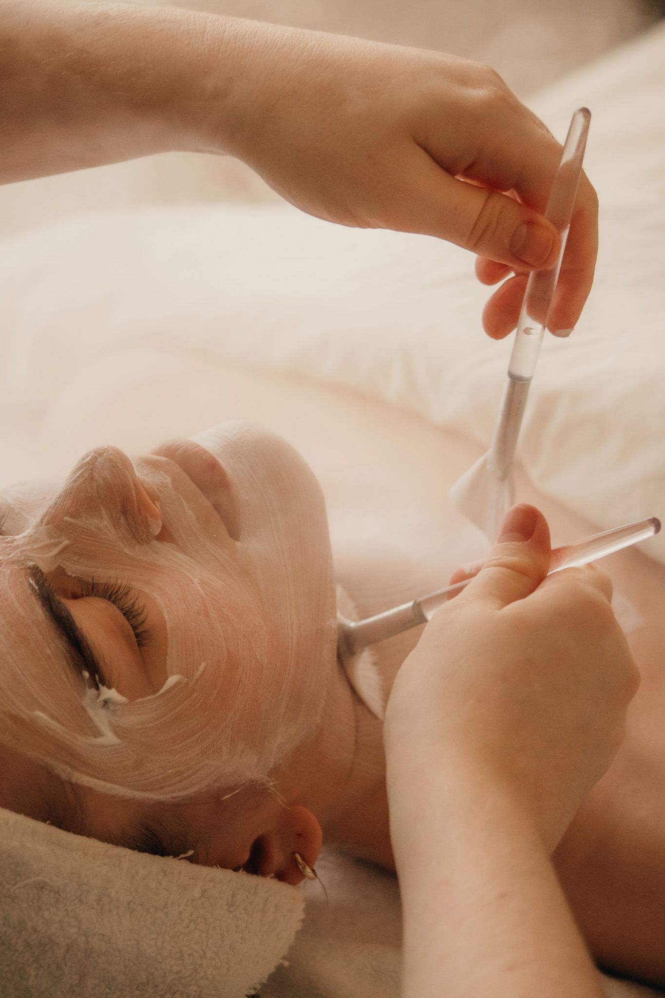 A woman enjoying a relaxing moment in a serene spa, with essential oils and candles in the background for a calming vibe.