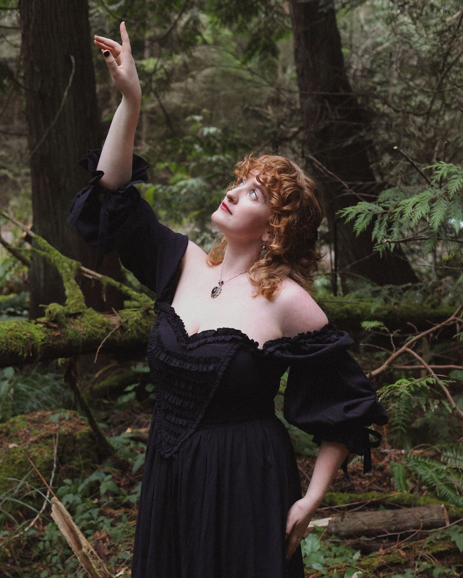 Outdoor photoshoot featuring a model in a stylish outfit, surrounded by scenic nature and soft, natural lighting.