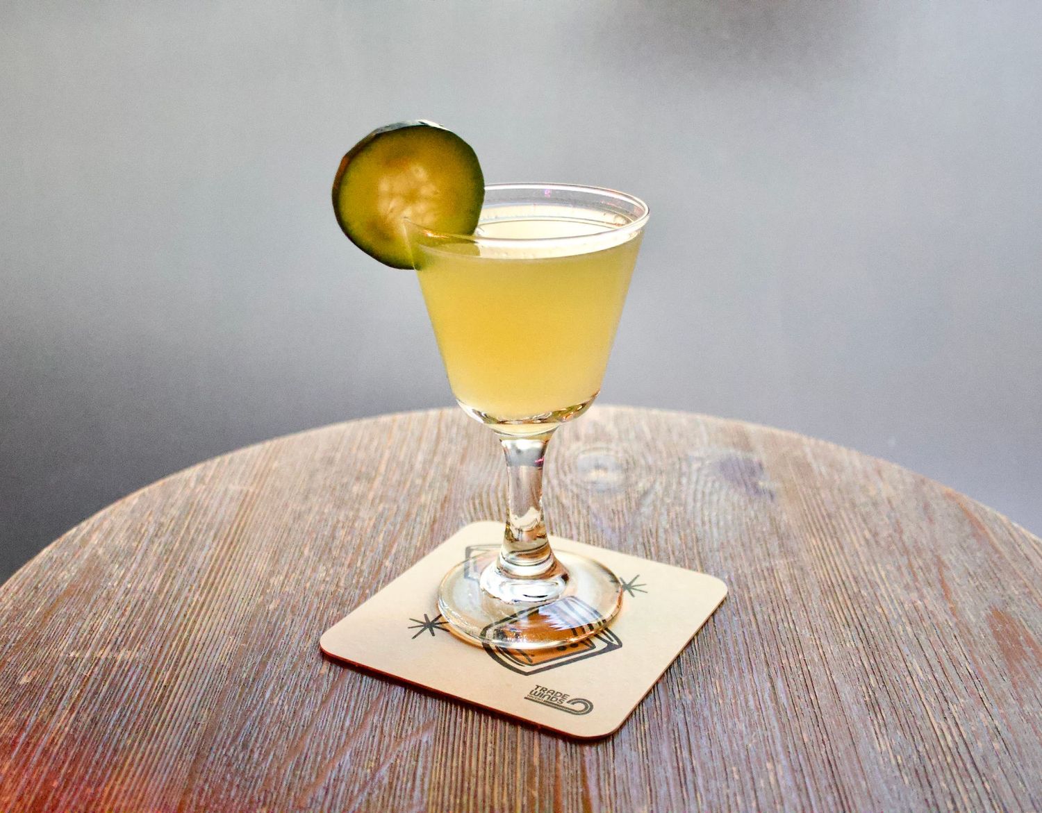 Cocktail photo in soft lighting on a wooden table.