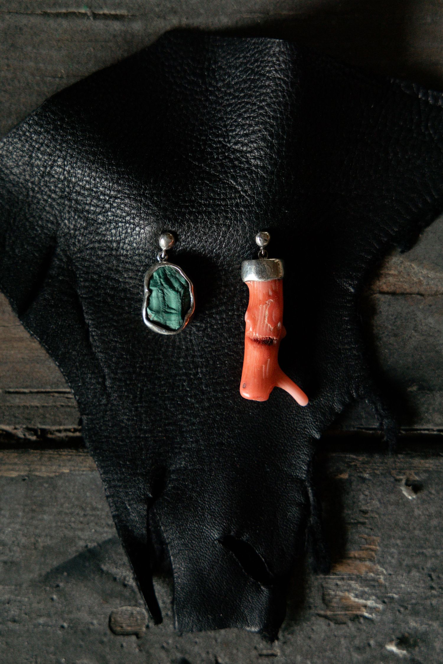 Sequence of close-up photos showing the creation of small polymer clay charms against a black leather background.