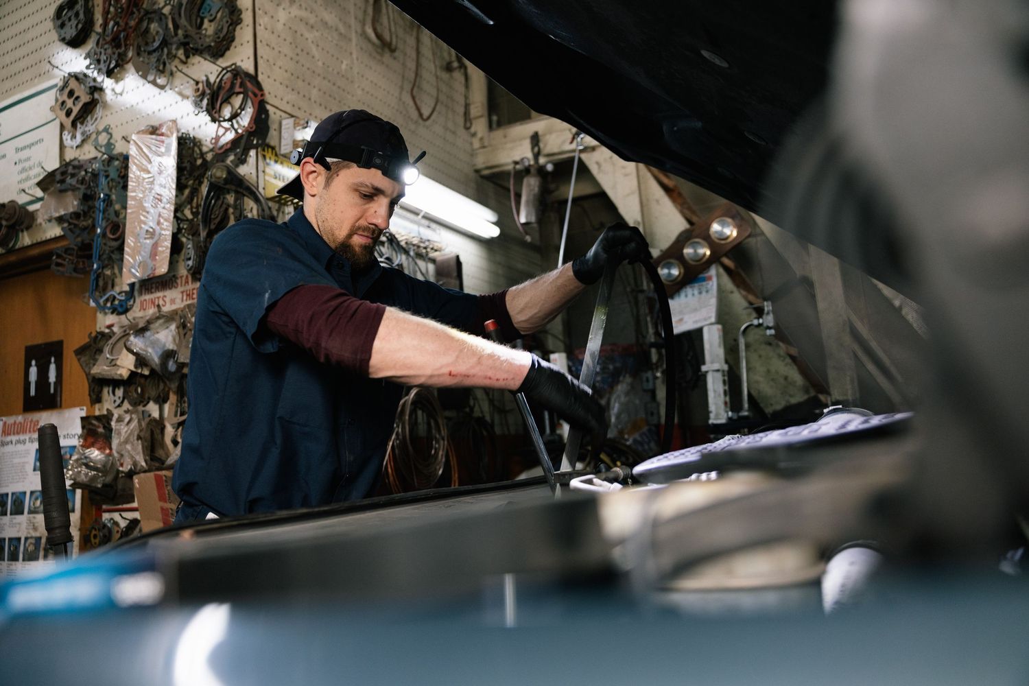 Baristas prepare coffee drinks and operate espresso machines in a bustling cafe environment.