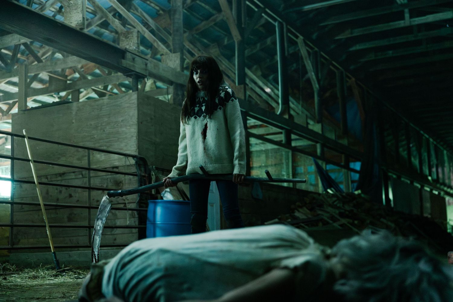 Dark atmospheric industrial setting shows multiple metal walkways and machinery illuminated by dramatic green lighting.