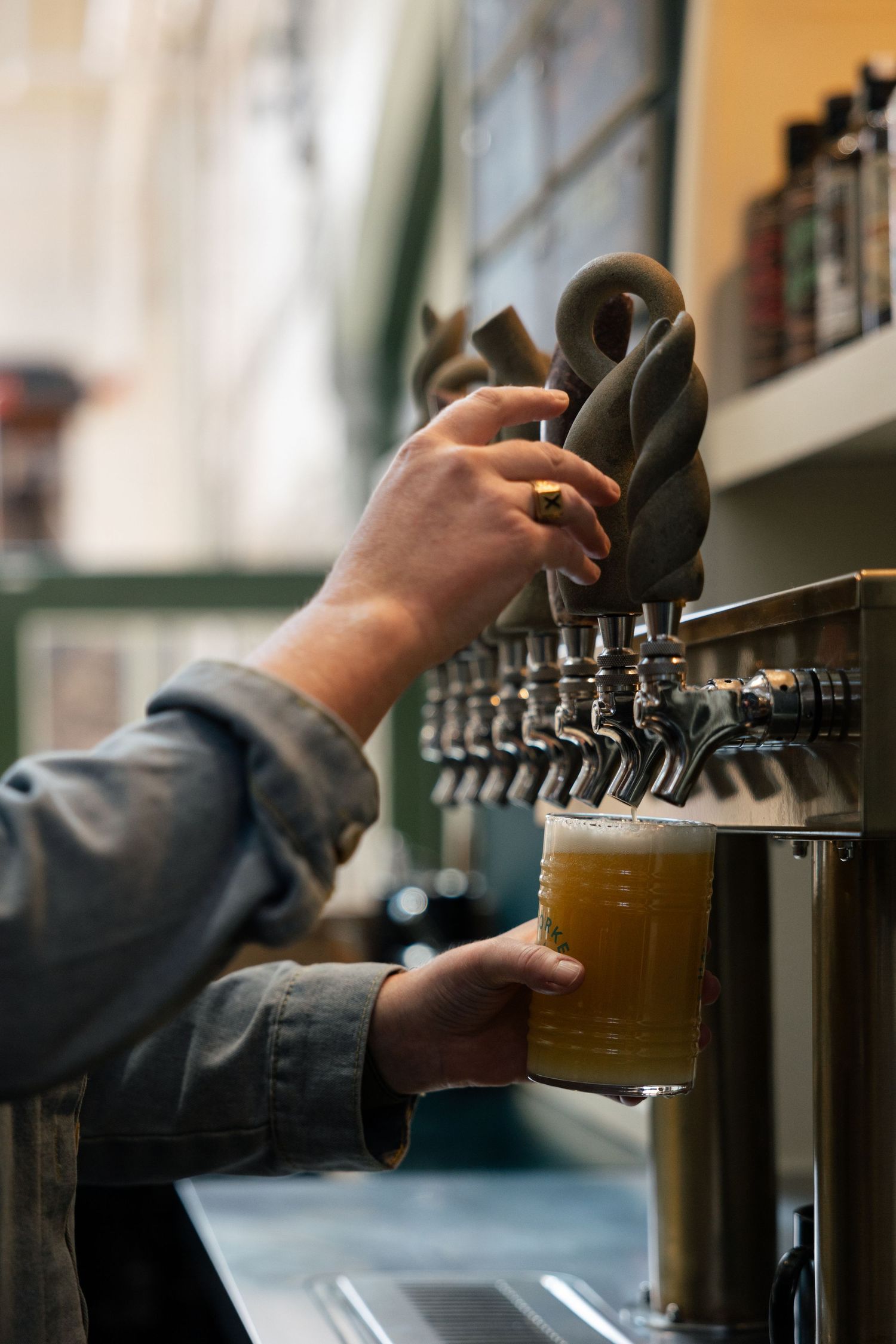 A series of photos showing hands pouring draft beer from multiple taps at a bar.