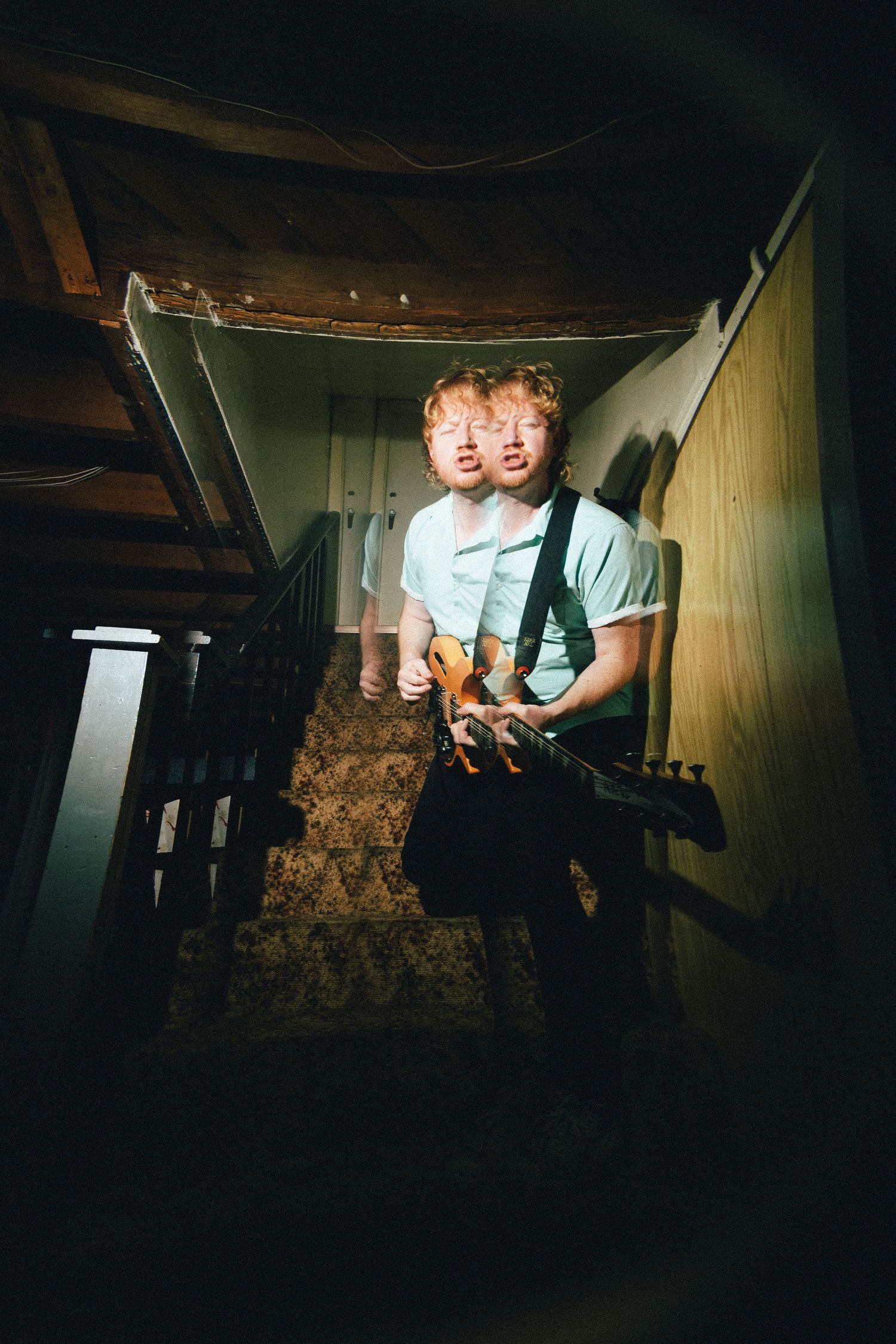 Double exposure effect shows figure with suspenders on dark staircase creating an eerie atmospheric scene.