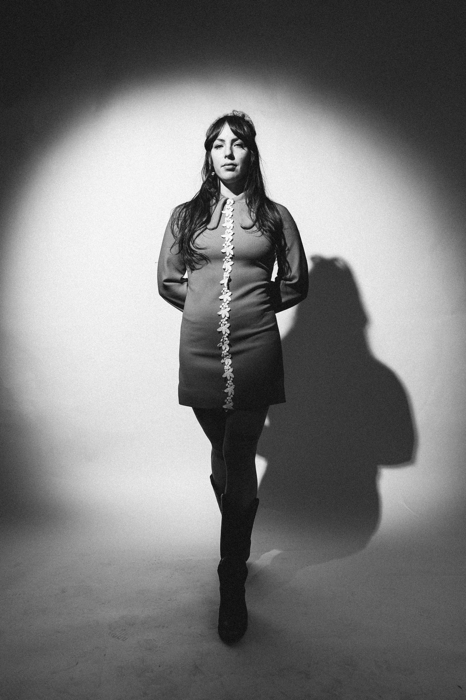 Black and white portrait sequence showing a person in dark clothing against light backdrop casting dramatic shadows.