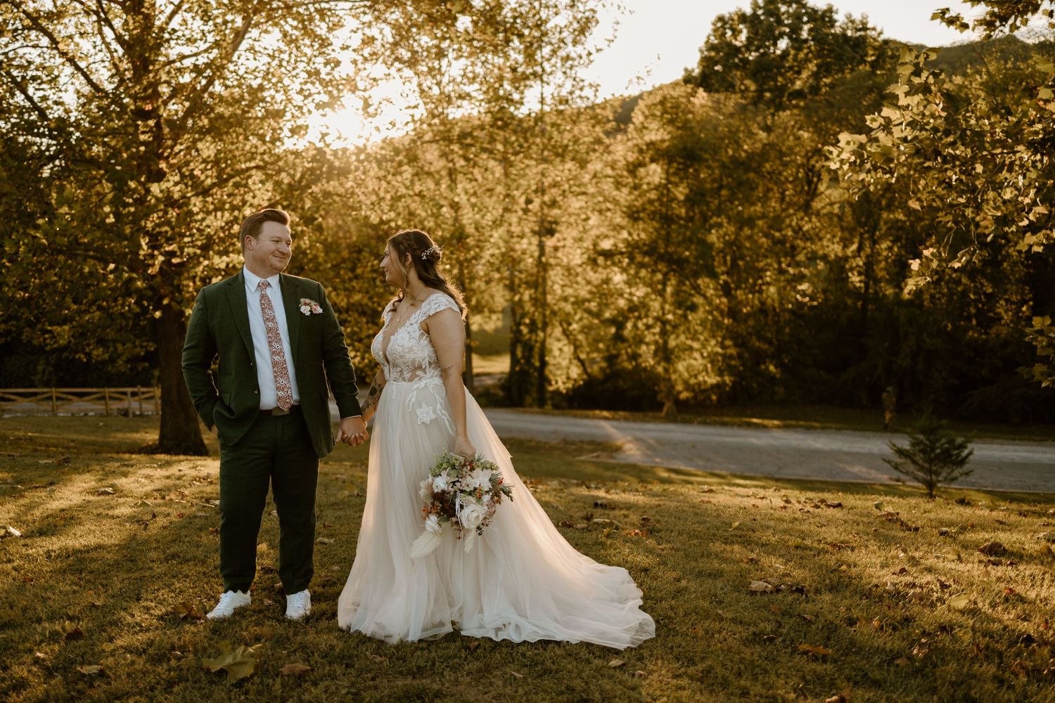 A romantic wedding photoshoot in a golden-lit outdoor setting at sunset with elegant formal attire.