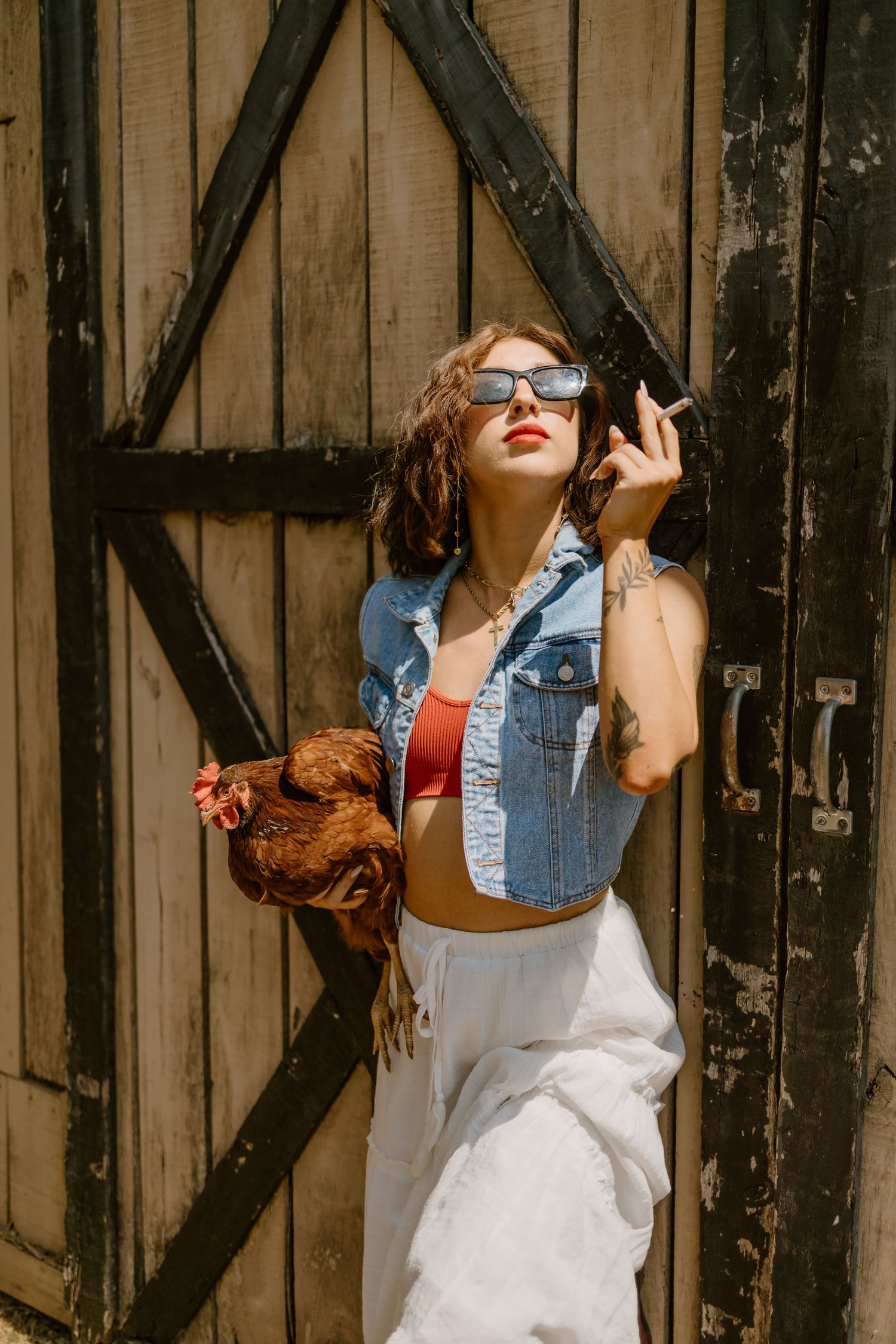 Artistic portrait against a rustic wooden barn wall with vintage styling.