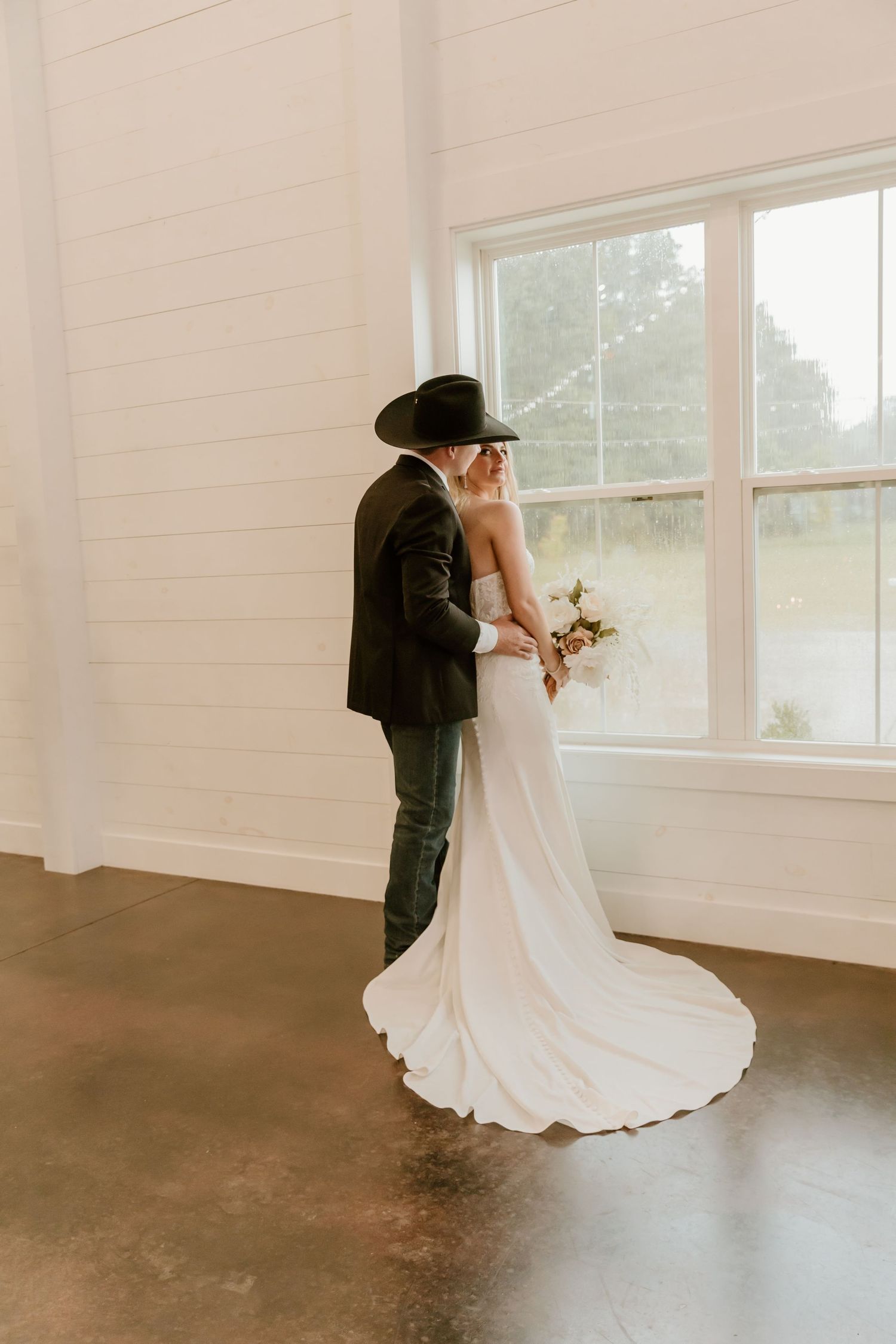 A sequence of romantic dance poses in a bright white room with large windows.