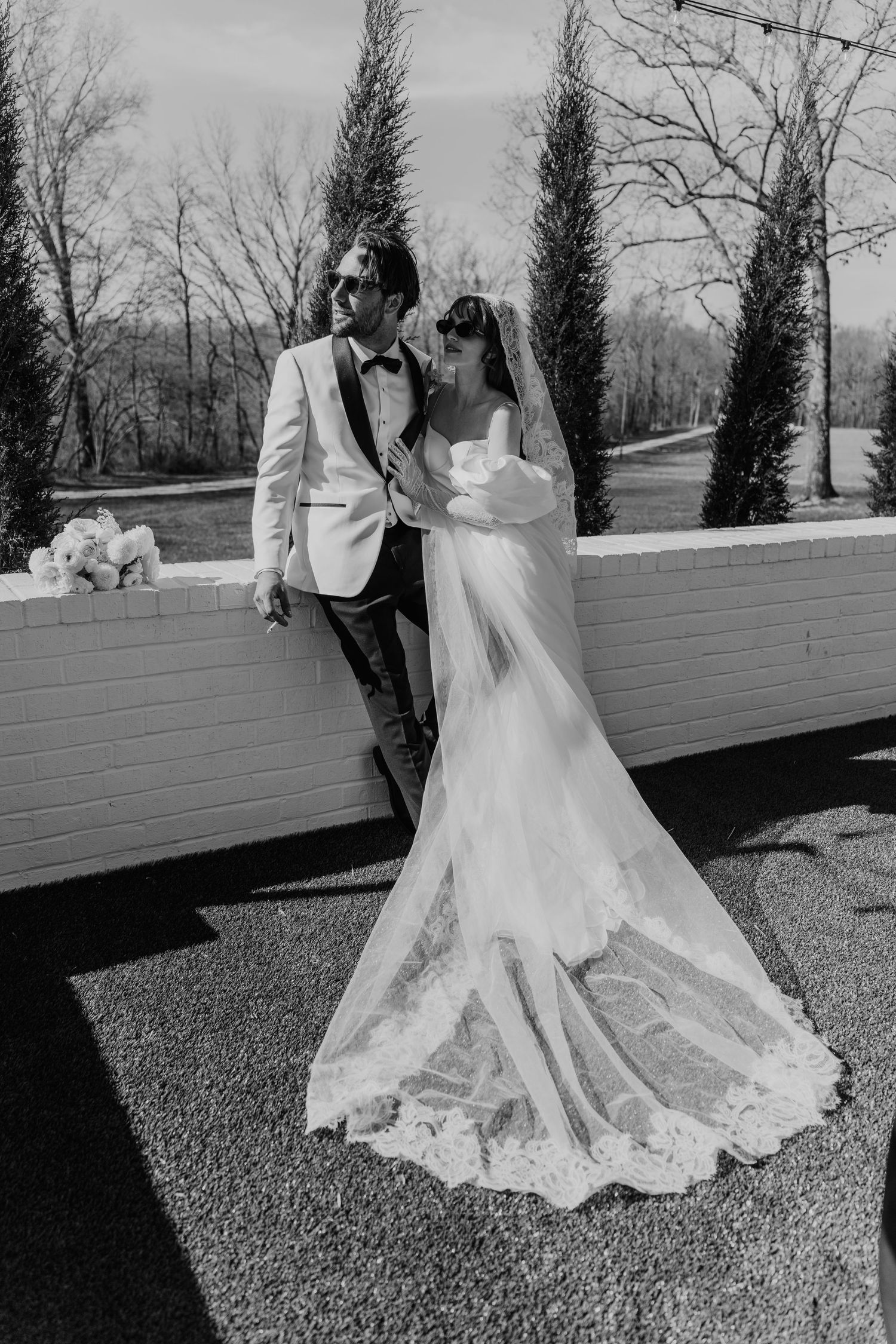 Black and white wedding photos on an outdoor deck with natural lighting.