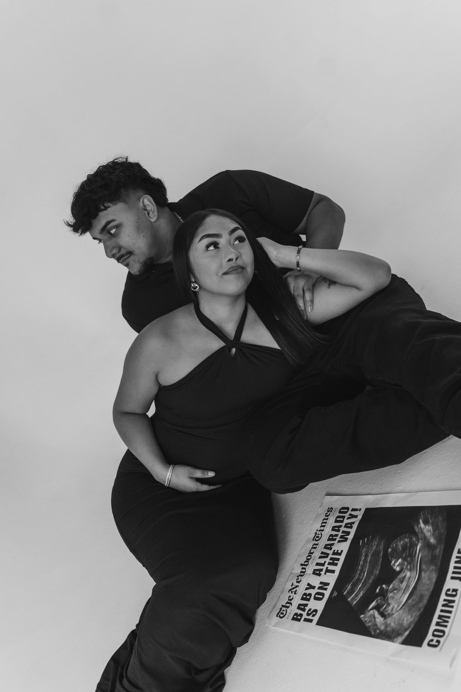 Black and white photo announcing pregnancy announcement.