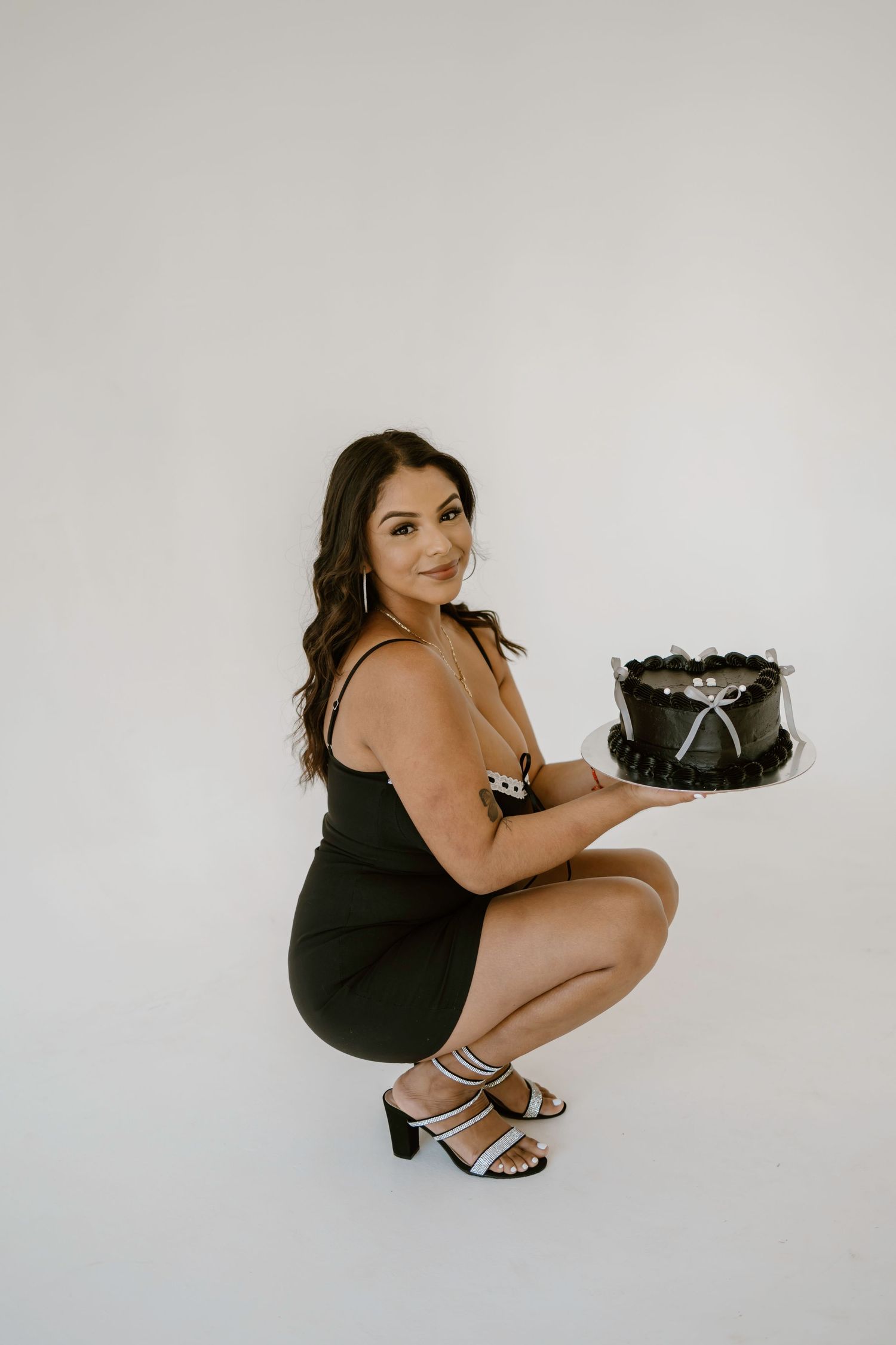 Artistic studio photoshoot featuring poses against minimalist white background.