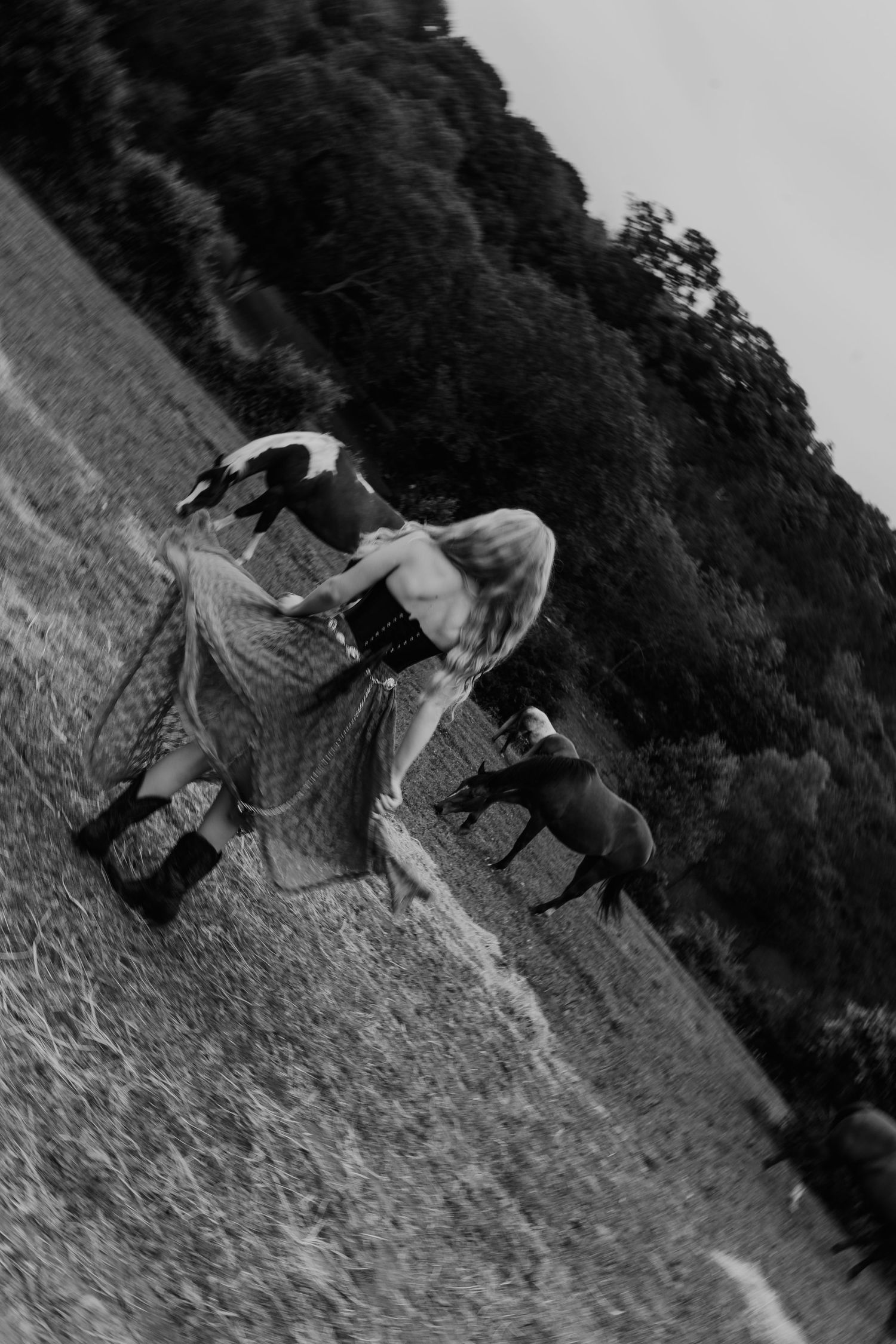 Black and white photos of playful movements on a grassy hillside.