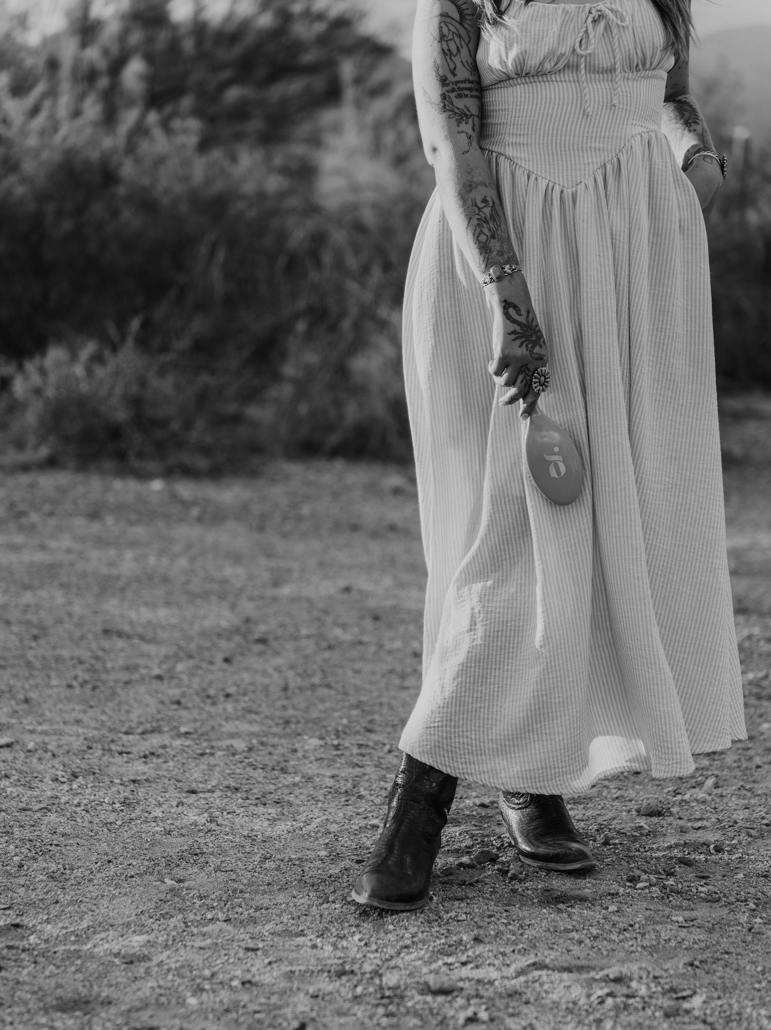 Black and white photos showing details of flowing white dresses against a desert backdrop.