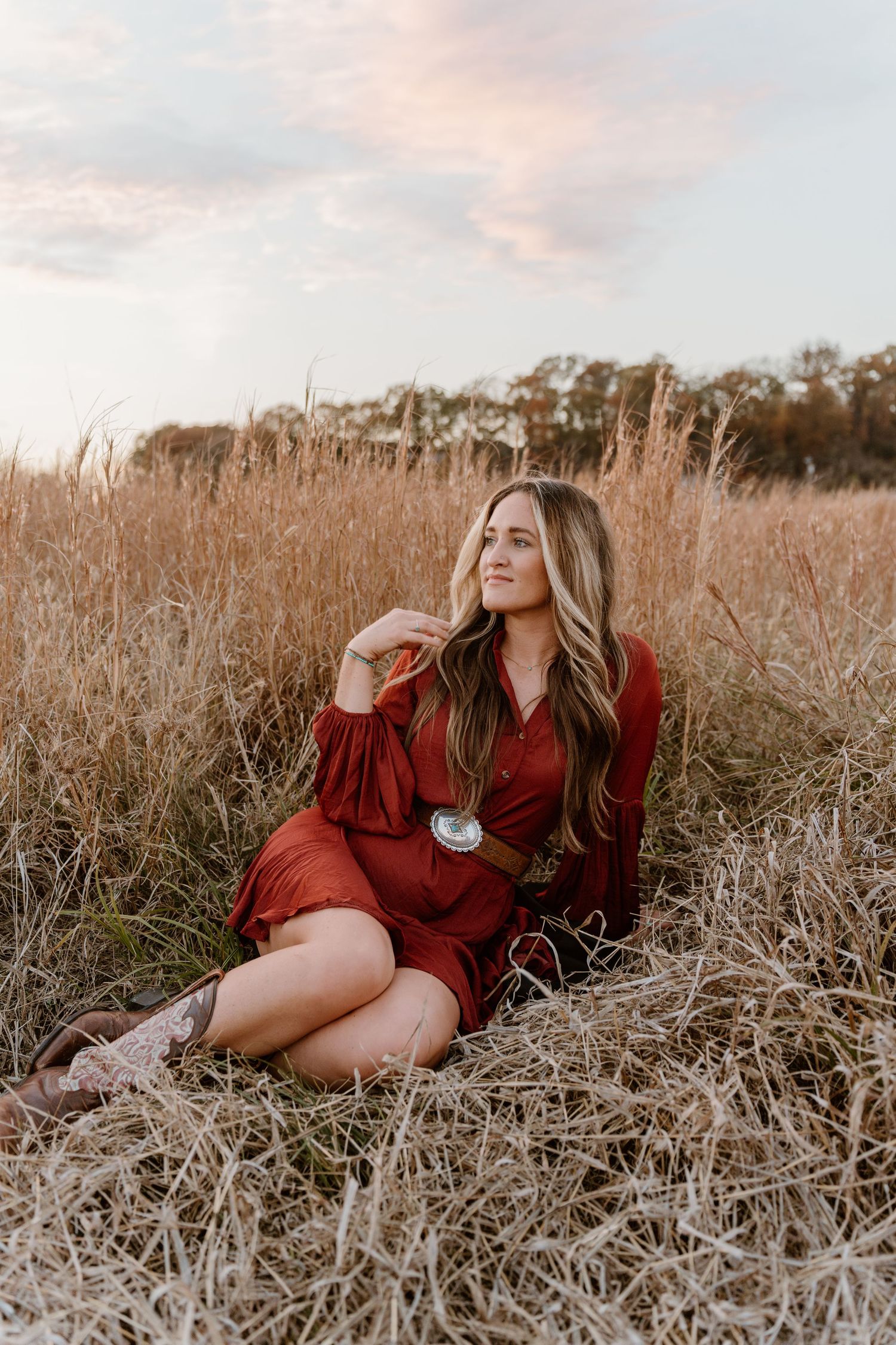 Western styled outfit in golden field during sunset in Nashville, Tennessee.